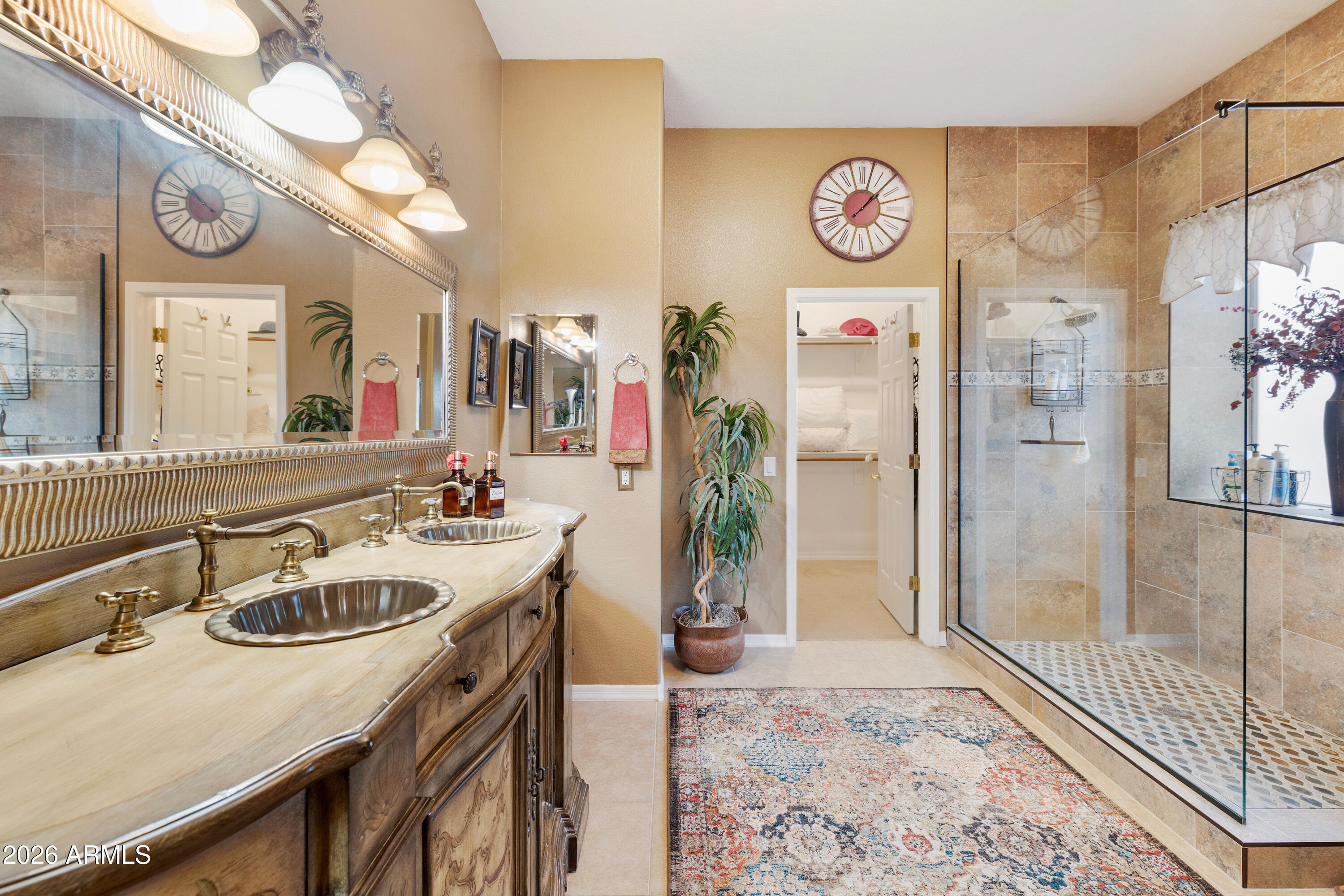 4100 East Strawberry Drive Gilbert, AZ 85298 - Photo 18 of 62 a bathroom with a sink a mirror and a shower