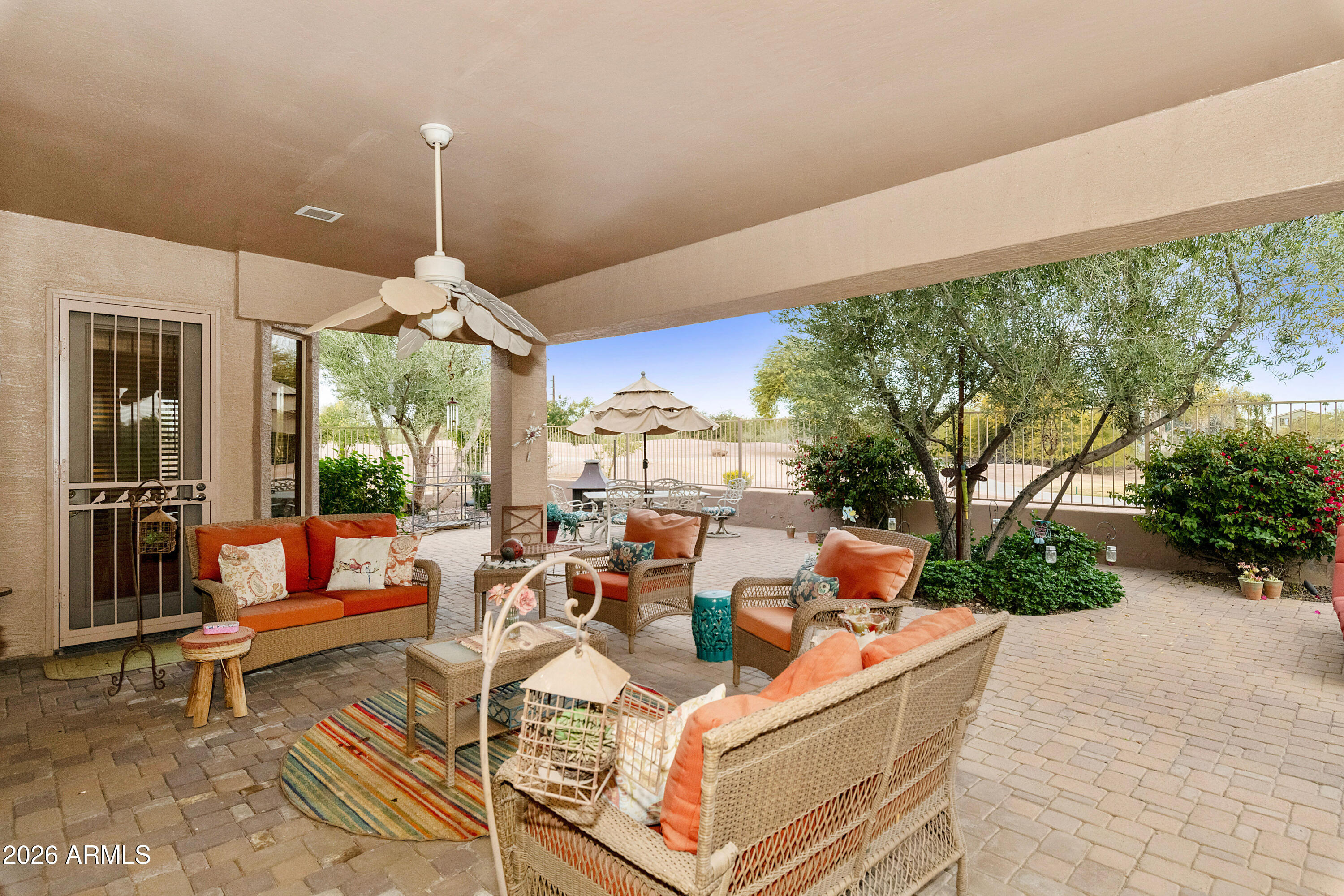 4100 East Strawberry Drive Gilbert, AZ 85298 - Photo 31 of 62 a living room with patio furniture and a chandelier