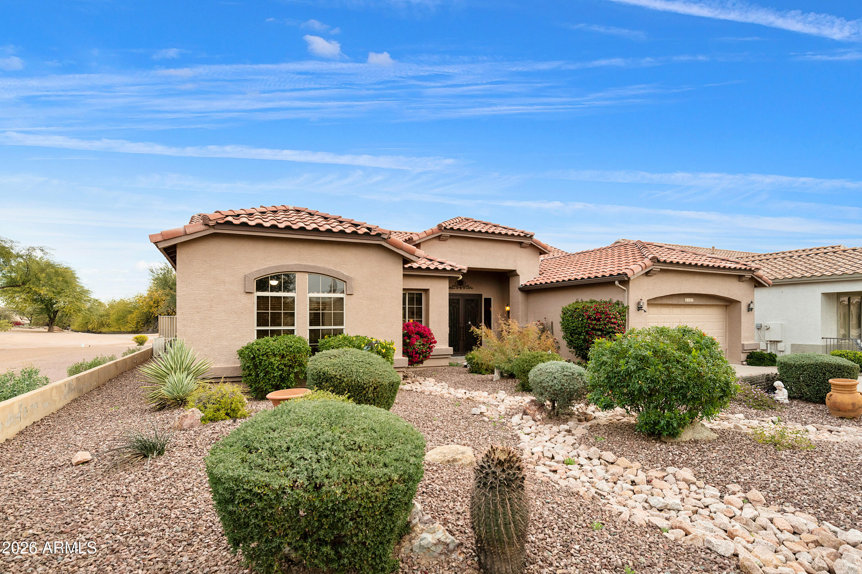 4100 East Strawberry Drive Gilbert, AZ 85298 - Photo 6 of 62 a view of a house with a small yard and potted plants
