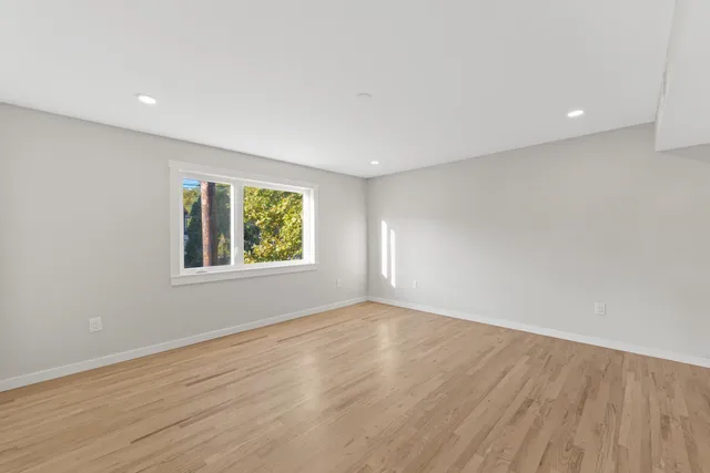 wooden floor in an empty room with a window