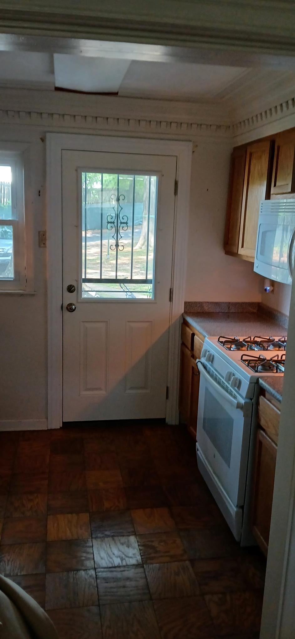 2991 Walnut Grove Road, Unit 2 Memphis, TN 38111 - Photo 5 of 8 a view of an empty room with wooden floor and a window