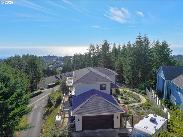 aerial view of a house with a yard and balcony