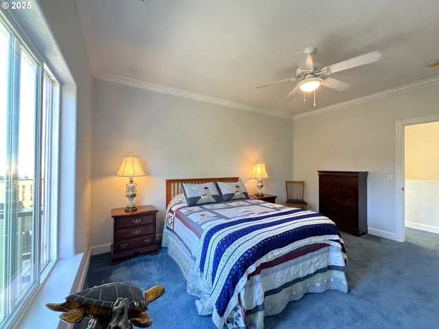 a bedroom with a bed a chandelier and a window