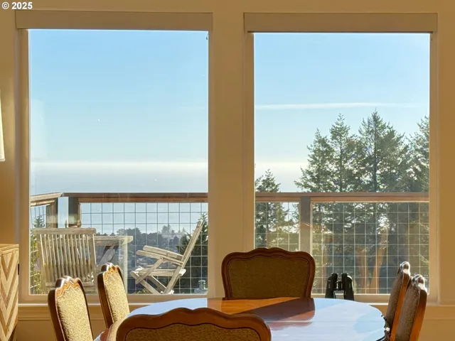 a living room with furniture and floor to ceiling windows