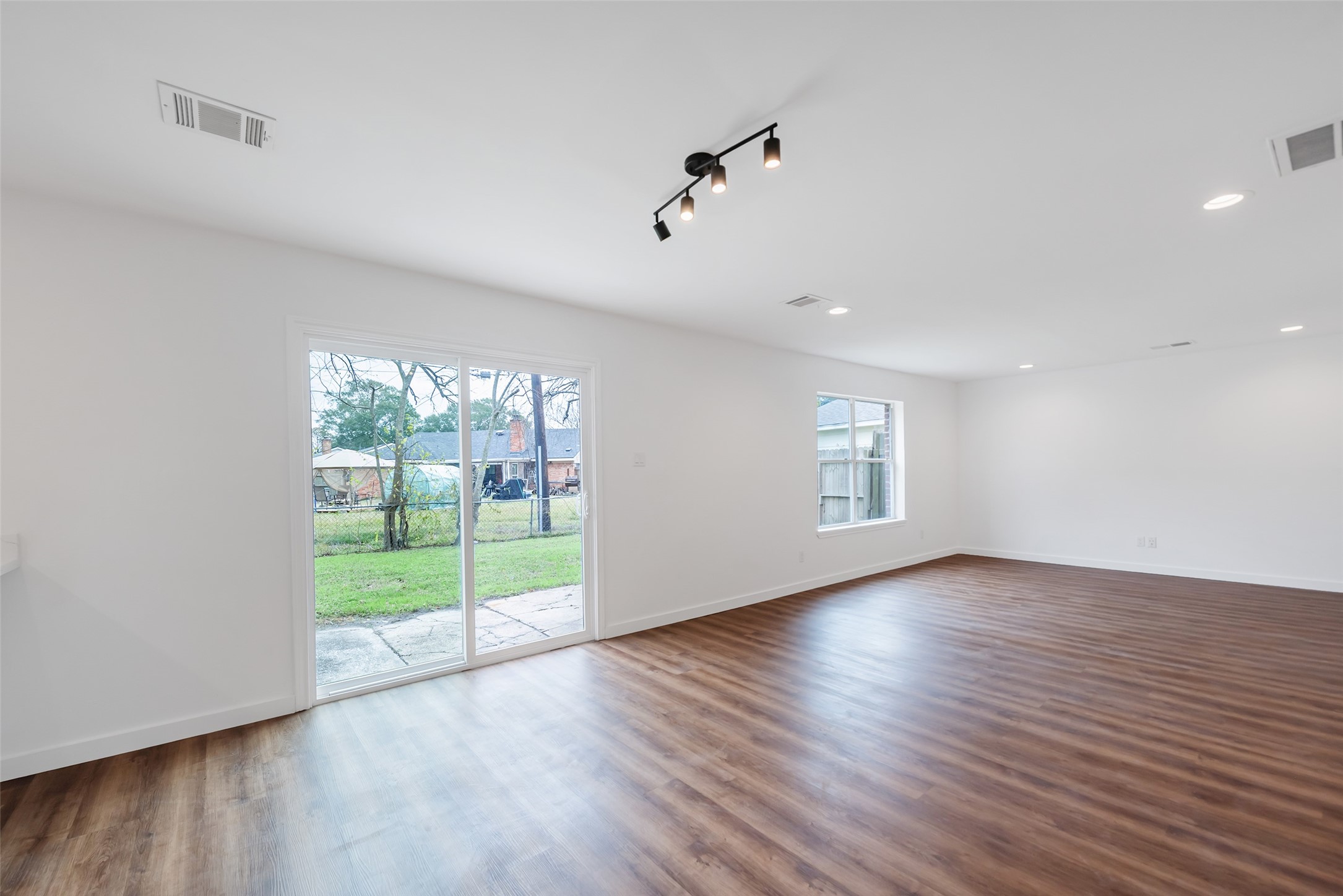 11703 North Perry Avenue Houston, TX 77071 - Photo 11 of 43 a view of an empty room with wooden floor and a window