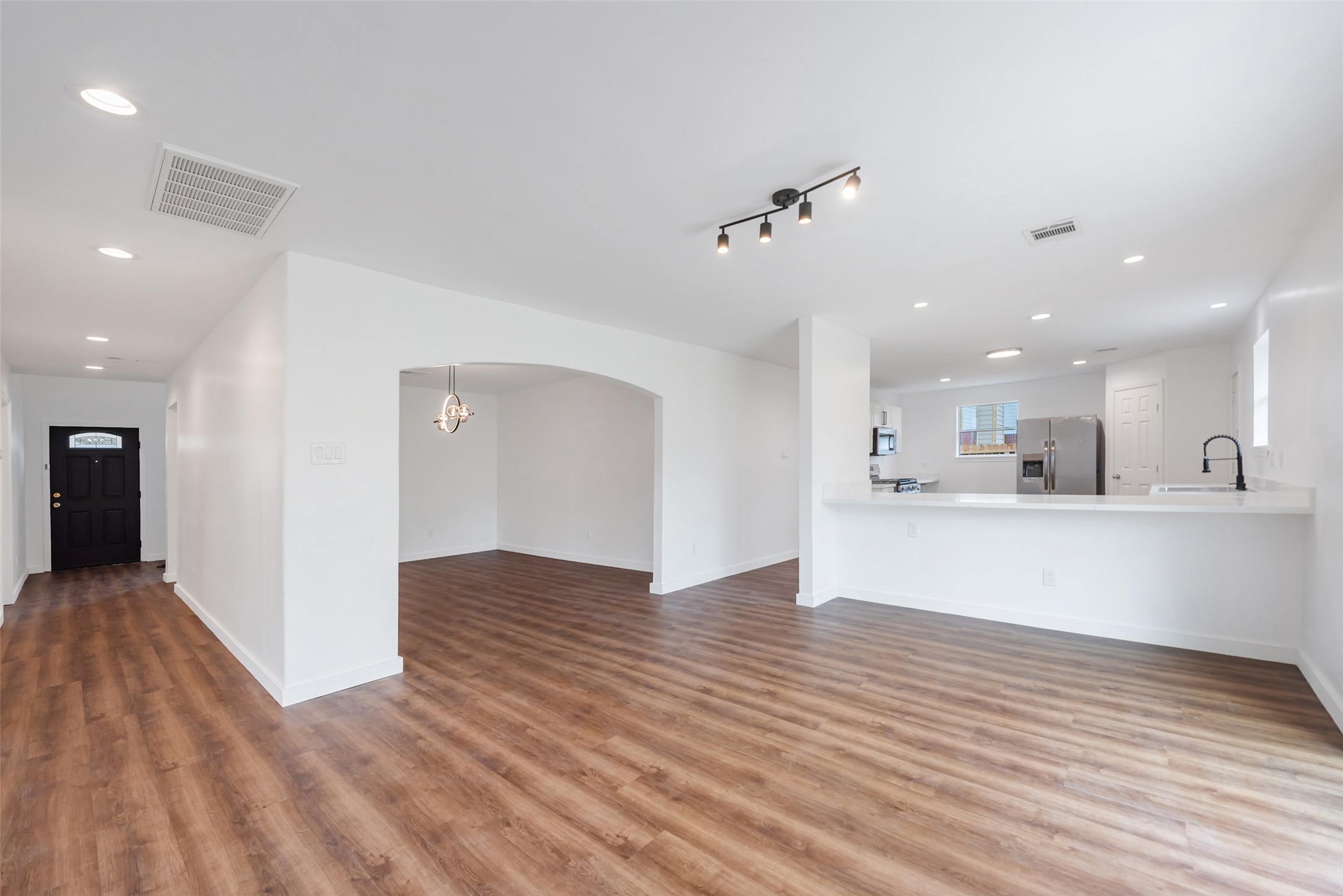 11703 North Perry Avenue Houston, TX 77071 - Photo 13 of 43 a view of kitchen and hall with wooden floor