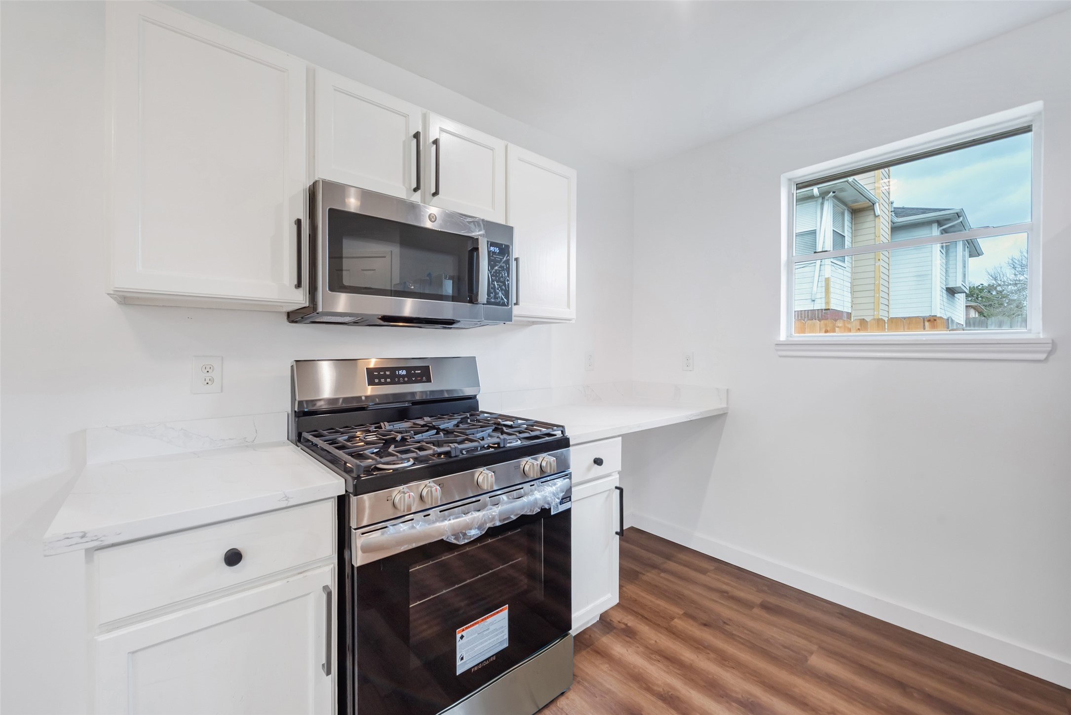 11703 North Perry Avenue Houston, TX 77071 - Photo 16 of 43 a kitchen with cabinets stainless steel appliances and wooden floor