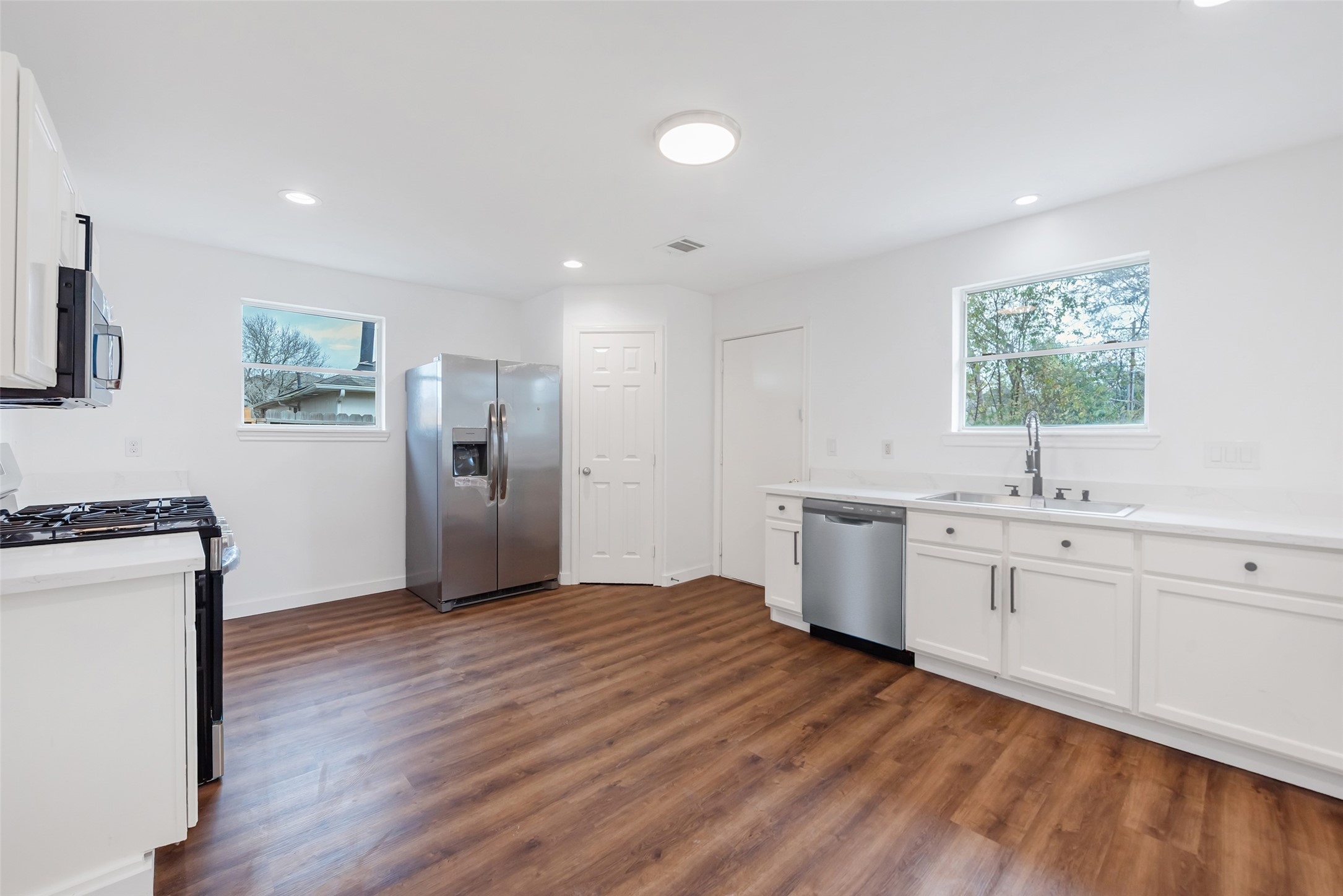 11703 North Perry Avenue Houston, TX 77071 - Photo 19 of 43 a view of cabinets with wooden floor and window