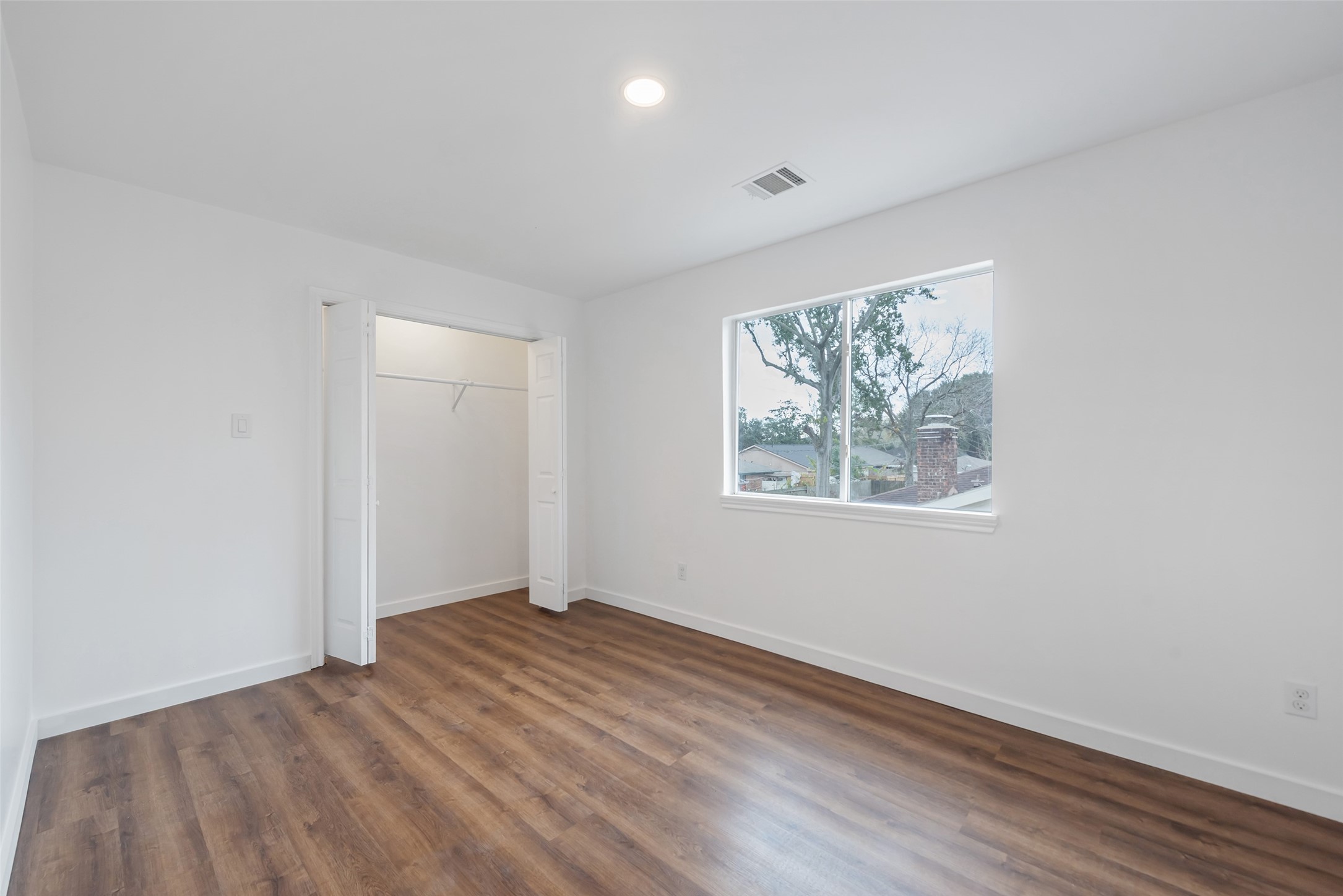11703 North Perry Avenue Houston, TX 77071 - Photo 28 of 43 an empty room with wooden floor and window