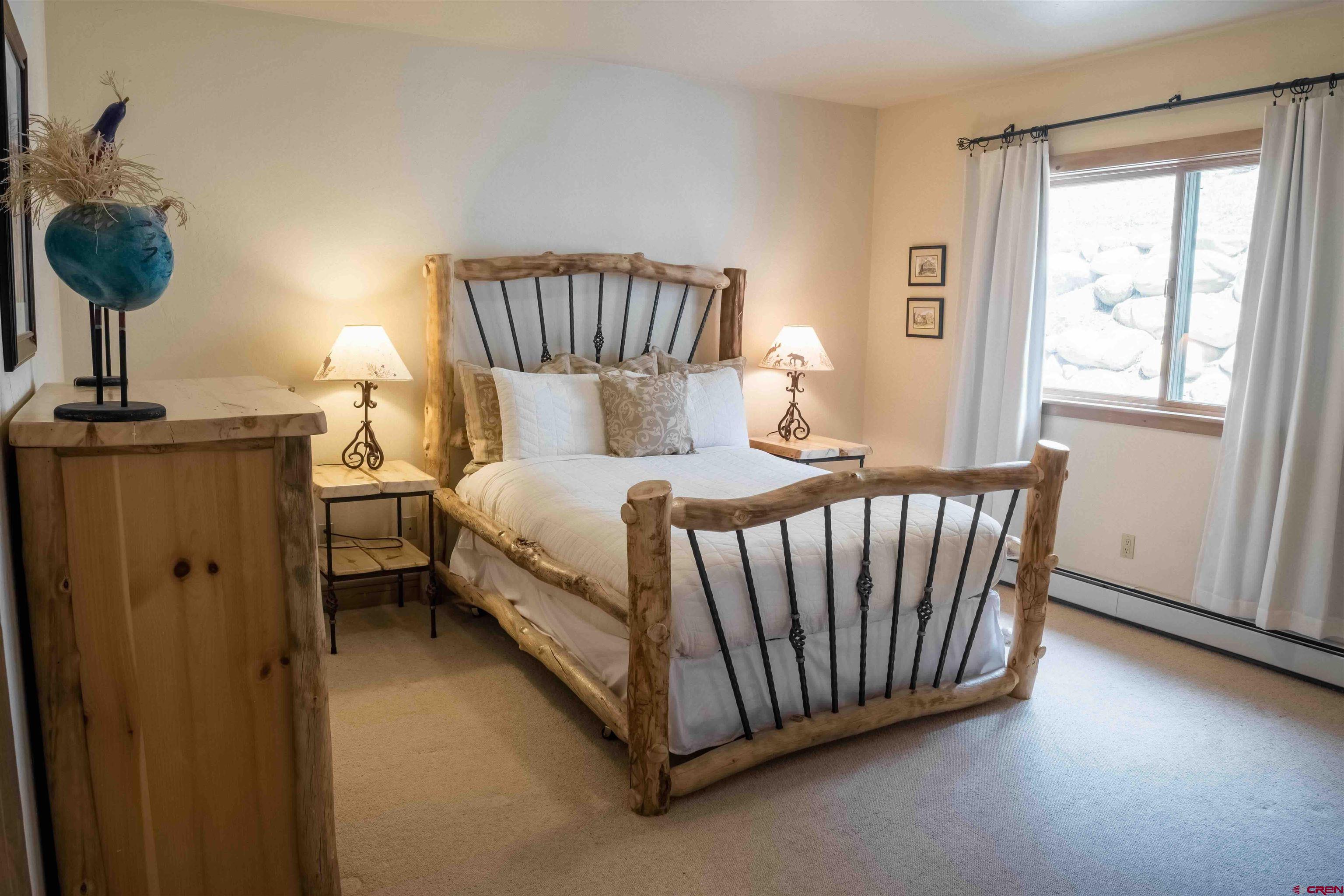 24 Hunter Hill Road, Unit 8 Crested Butte, CO 81225 - Photo 11 of 34 a bedroom with bed and a window