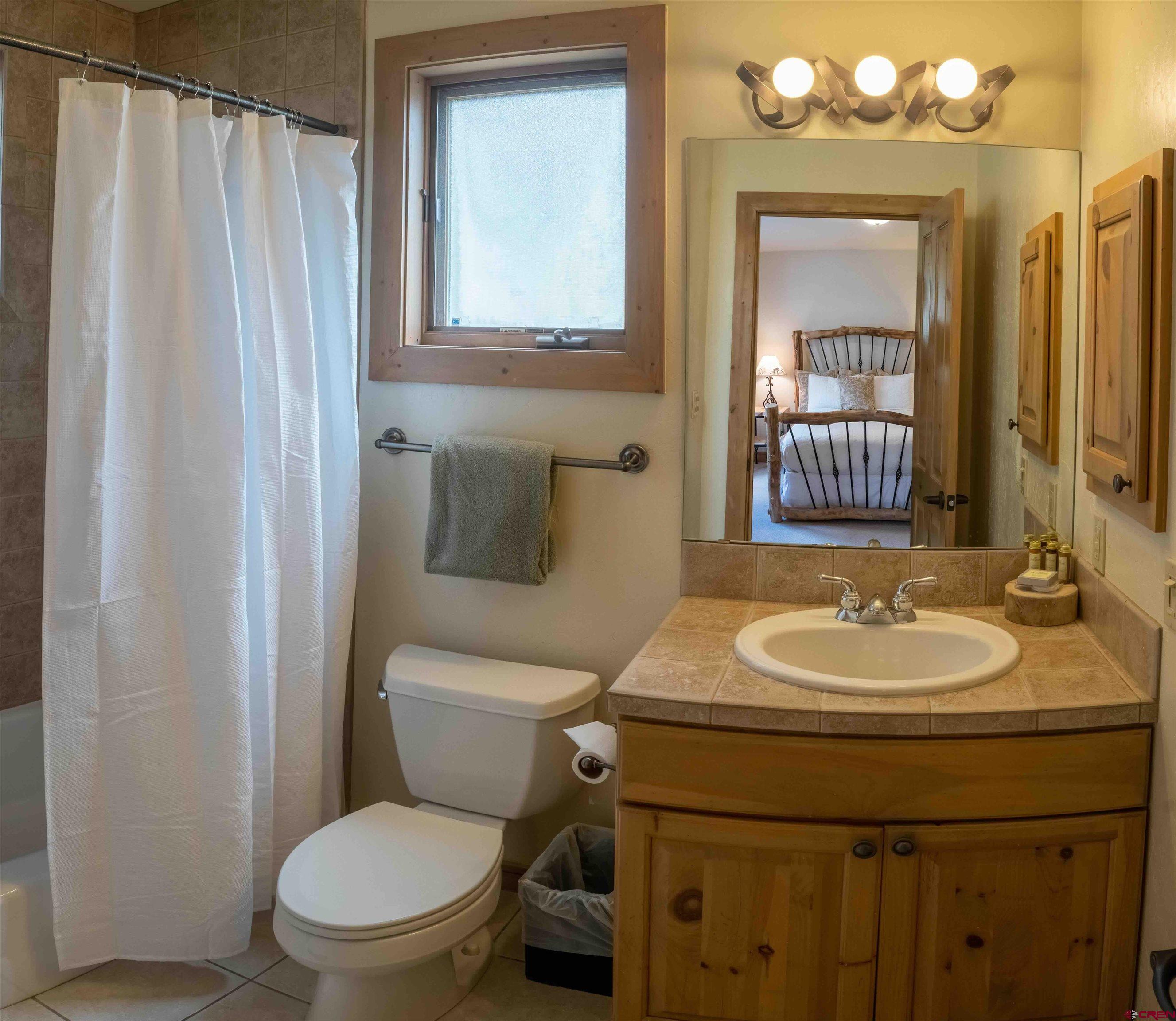 24 Hunter Hill Road, Unit 8 Crested Butte, CO 81225 - Photo 12 of 34 a bathroom with a toilet sink and mirror