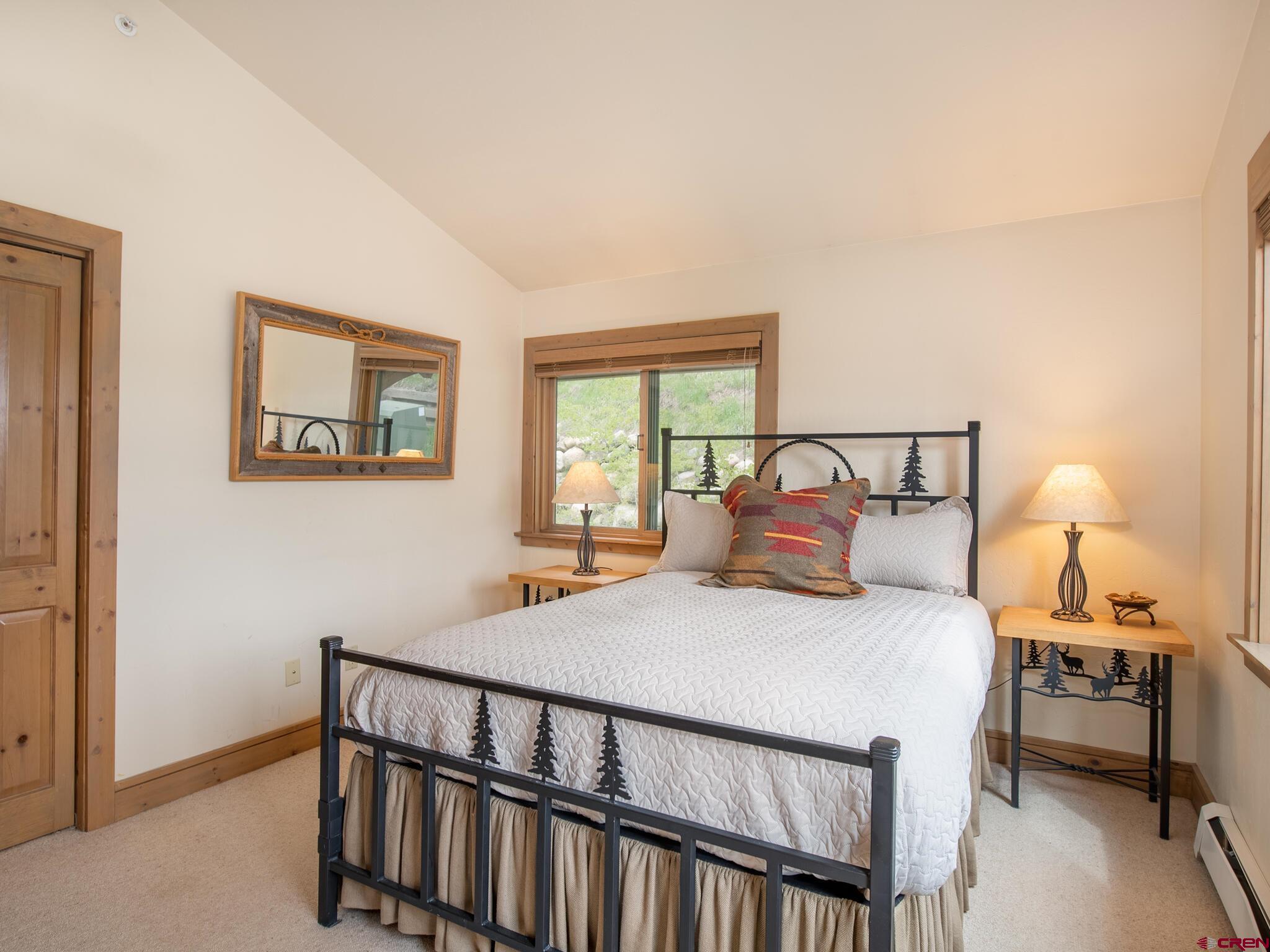 24 Hunter Hill Road, Unit 8 Crested Butte, CO 81225 - Photo 14 of 34 a bedroom with a bed and a window