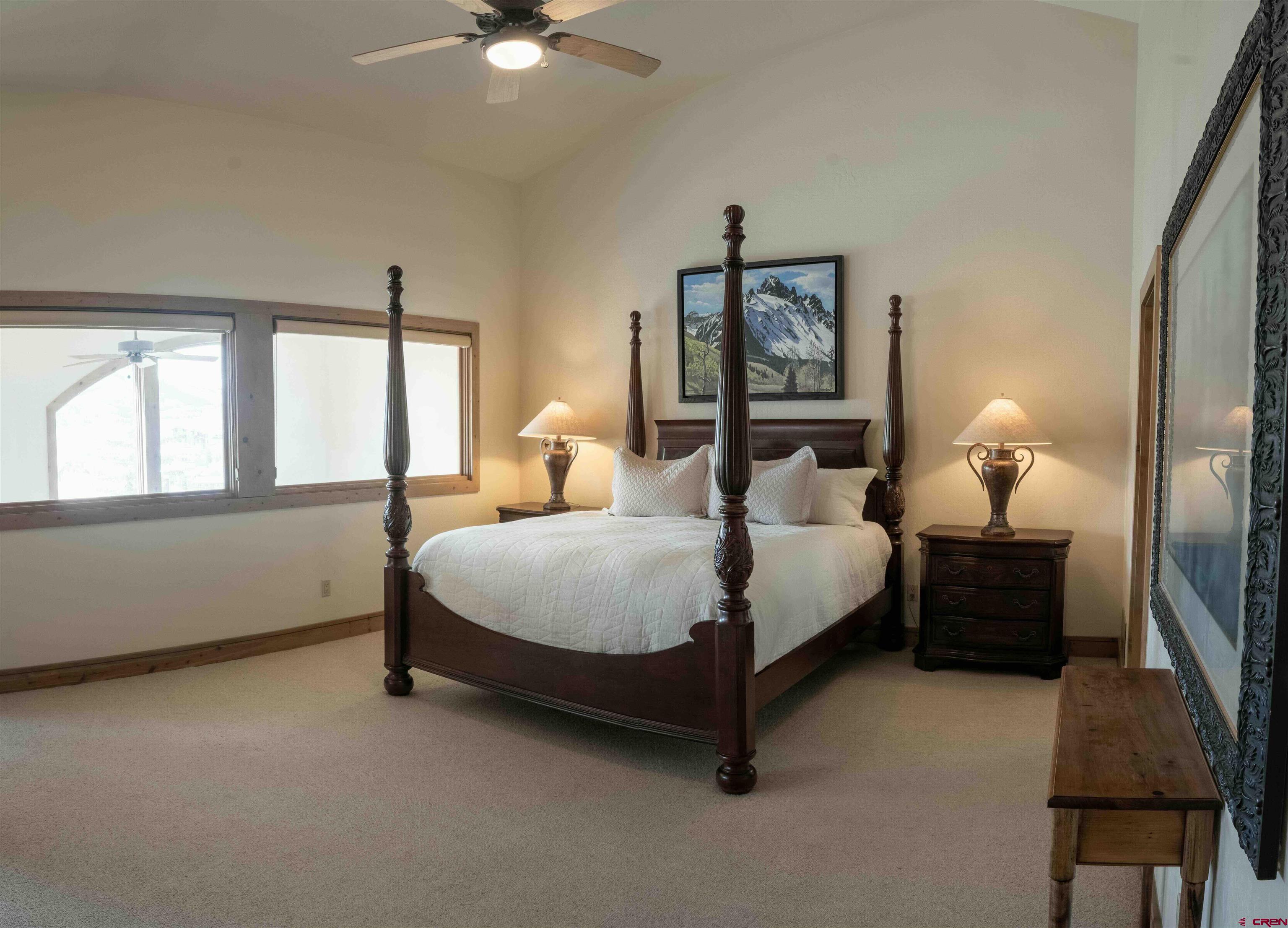 24 Hunter Hill Road, Unit 8 Crested Butte, CO 81225 - Photo 16 of 34 a spacious bedroom with a bed window and wall painting