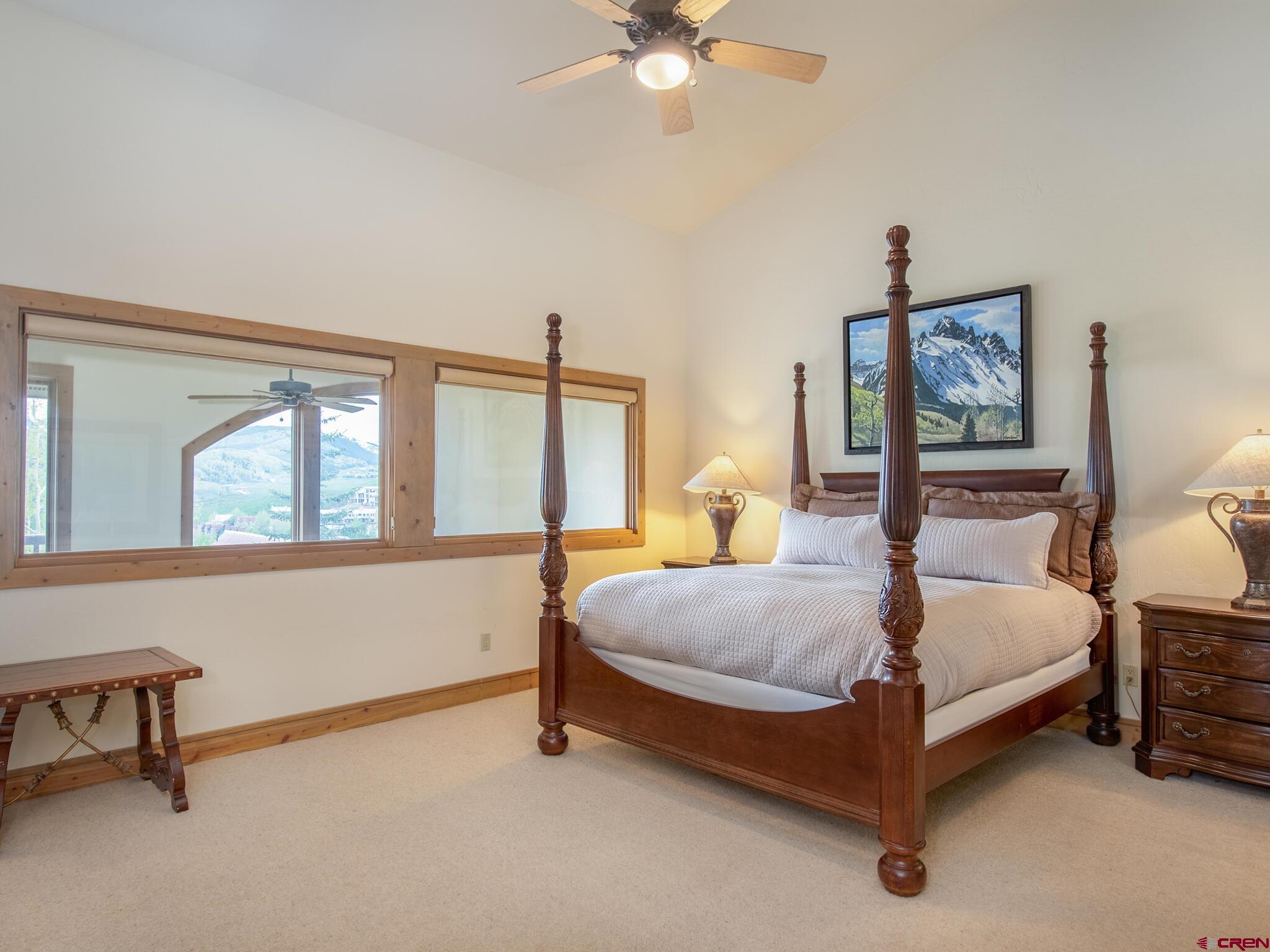 24 Hunter Hill Road, Unit 8 Crested Butte, CO 81225 - Photo 18 of 34 a bedroom with a bed and a chandelier