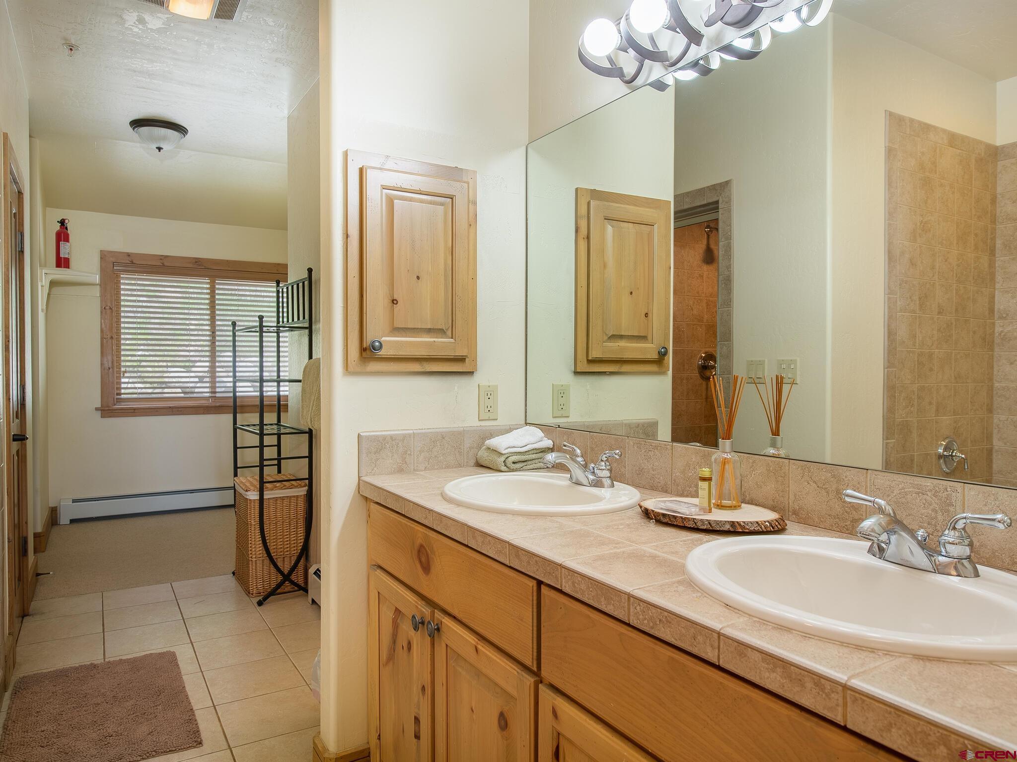 24 Hunter Hill Road, Unit 8 Crested Butte, CO 81225 - Photo 22 of 34 a bathroom with a double vanity sink and a mirror