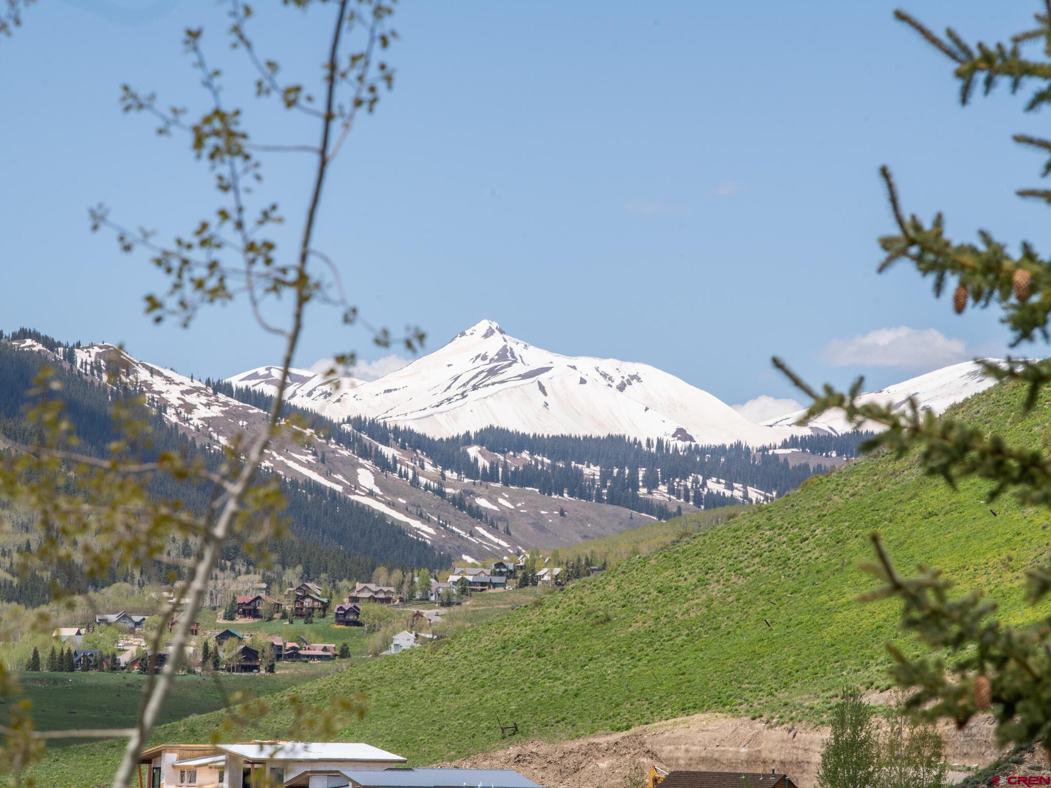 24 Hunter Hill Road, Unit 8 Crested Butte, CO 81225 - Photo 28 of 34 a view of a backyard with plants and a lake view