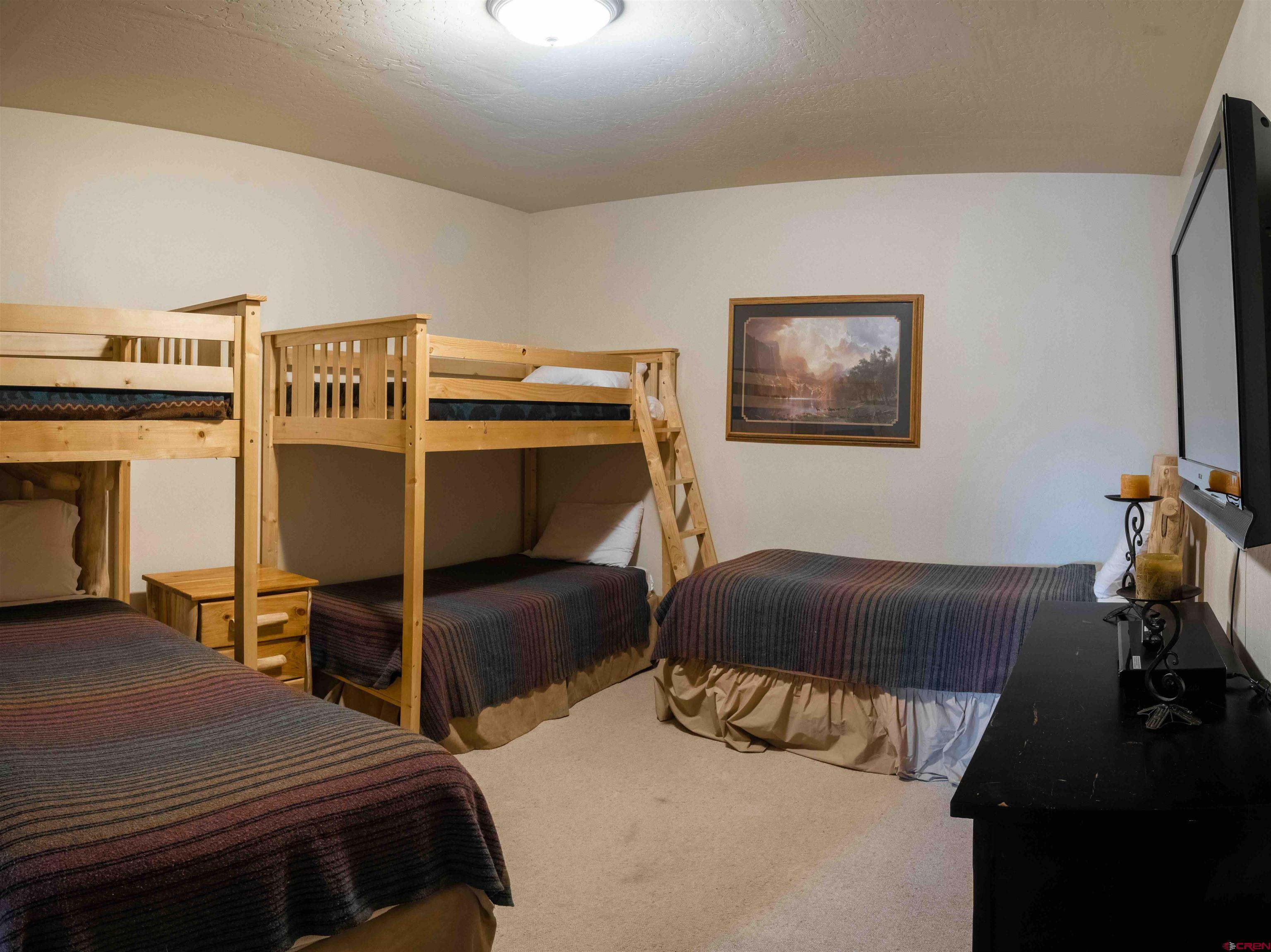 24 Hunter Hill Road, Unit 8 Crested Butte, CO 81225 - Photo 6 of 34 a bedroom with a bed and a ceiling fan