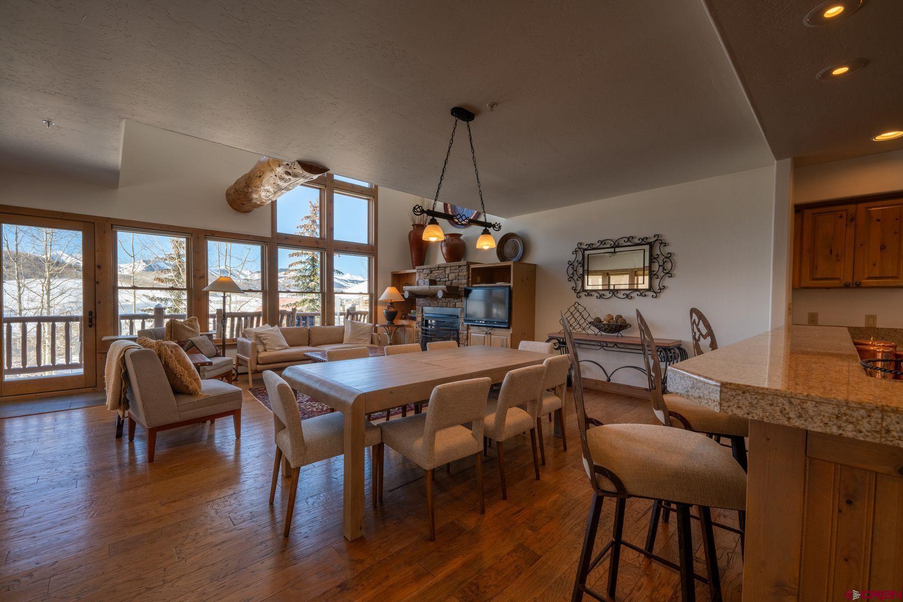 24 Hunter Hill Road, Unit 8 Crested Butte, CO 81225 - Photo 7 of 34 a view of a dining room with furniture window and wooden floor