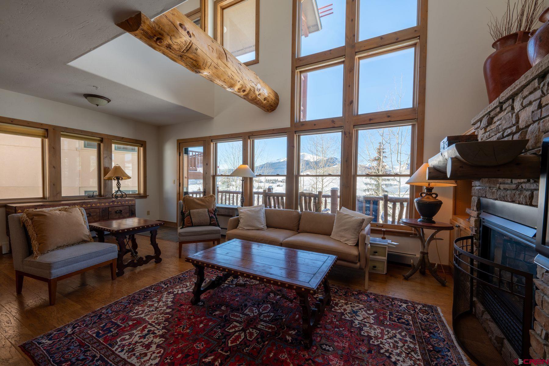 24 Hunter Hill Road, Unit 8 Crested Butte, CO 81225 - Photo 9 of 34 a living room with furniture a rug and a large window