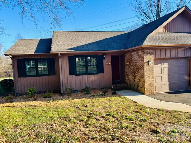 a view of a house with a wooden fence