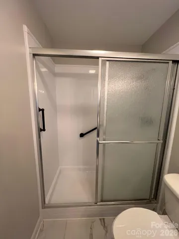 a bathroom with a glass shower door