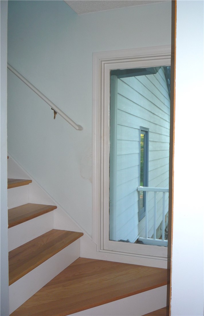 109 Lake Ridge Circle Walhalla, SC 29691 - Photo 13 of 27 Gleaming hardwood steps rise alongside a tall window framing views of the exterior siding.