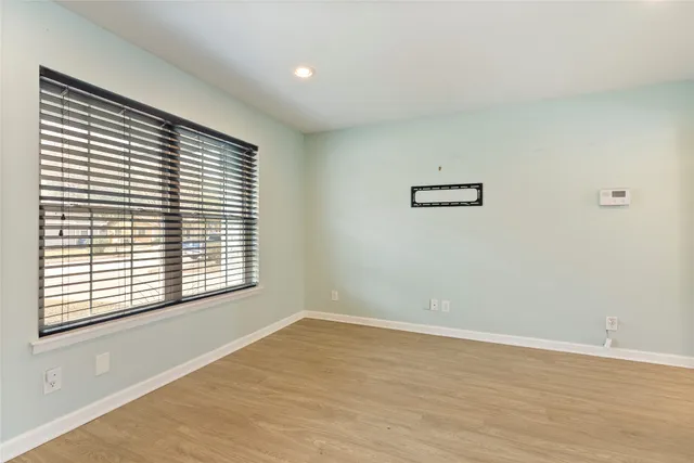 a view of an empty room with glass door