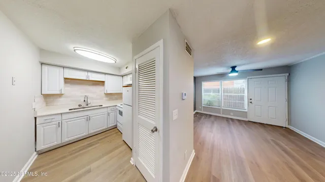 a kitchen with stainless steel appliances granite countertop a stove and a sink