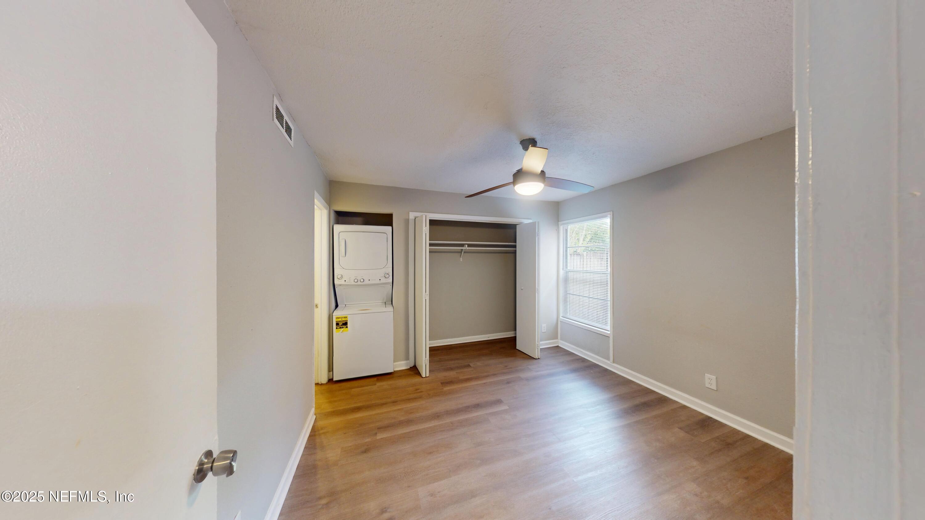 2887 Post Street, Unit 1 Jacksonville, FL 32205 - Photo 5 of 7 an empty room with wooden floor and windows