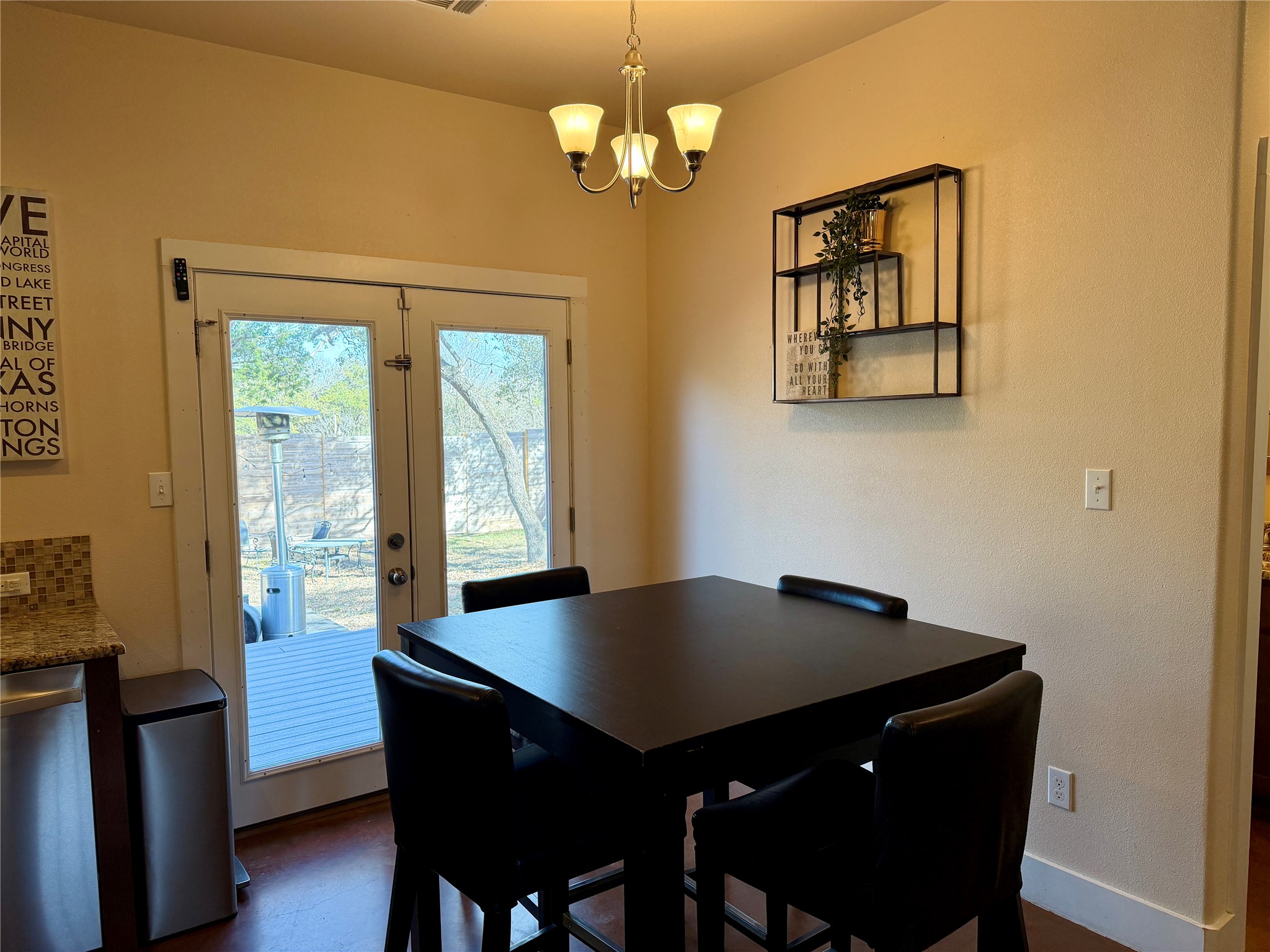 5503 Hiline Road Austin, TX 78734 - Photo 4 of 20 Dining room featuring french doors and a chandelier