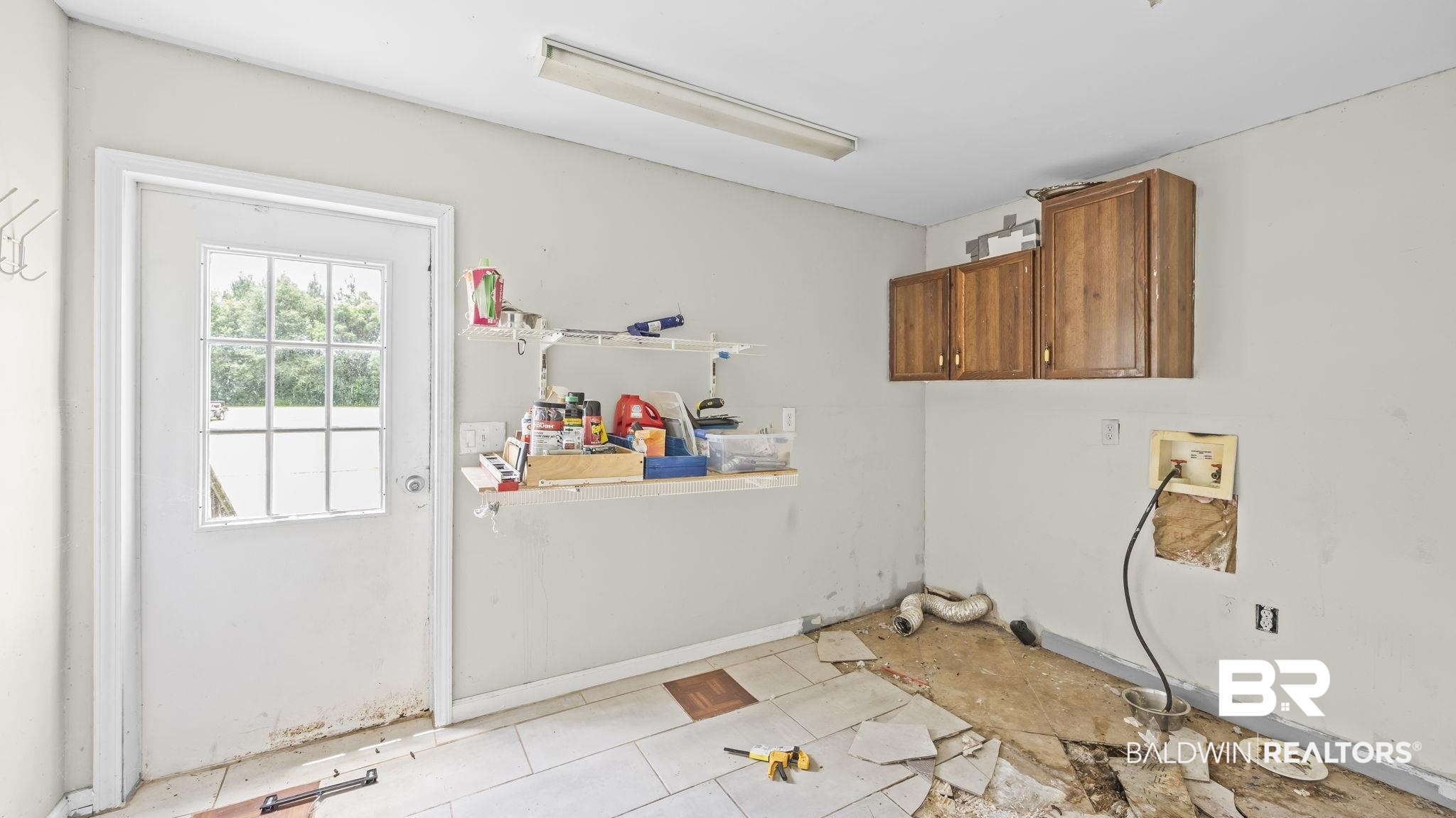 34985b Spring Road South, Unit B Stapleton, AL 36578 - Photo 16 of 31 Utility room featuring wall-mounted cabinetry, a windowed exterior door, and plumbing hookups