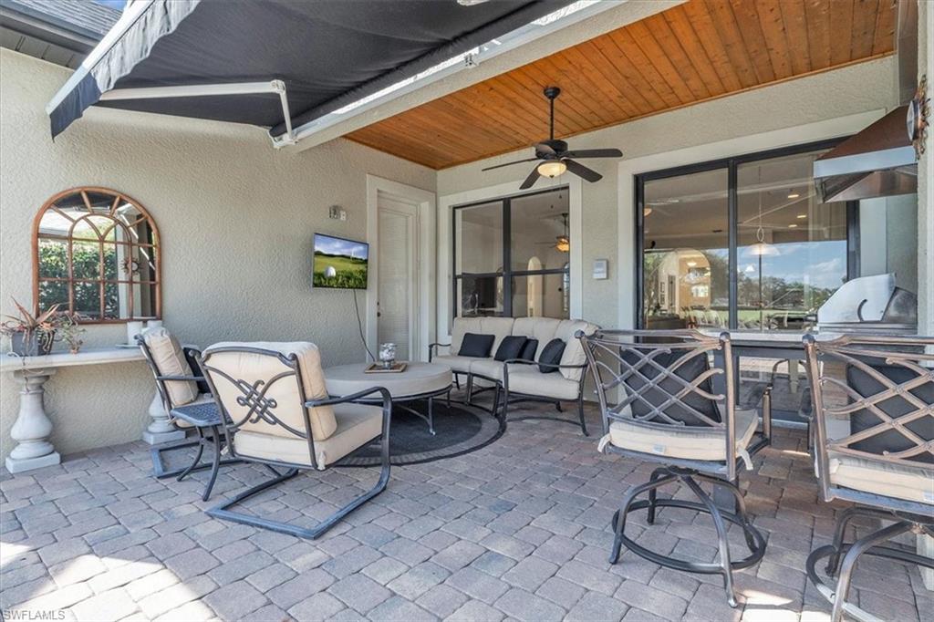 16436 Windsor Way Alva, FL 33920 - Photo 34 of 50 Lanai with wood inlays in the ceiling, outdoor kitchen, and retractable awning