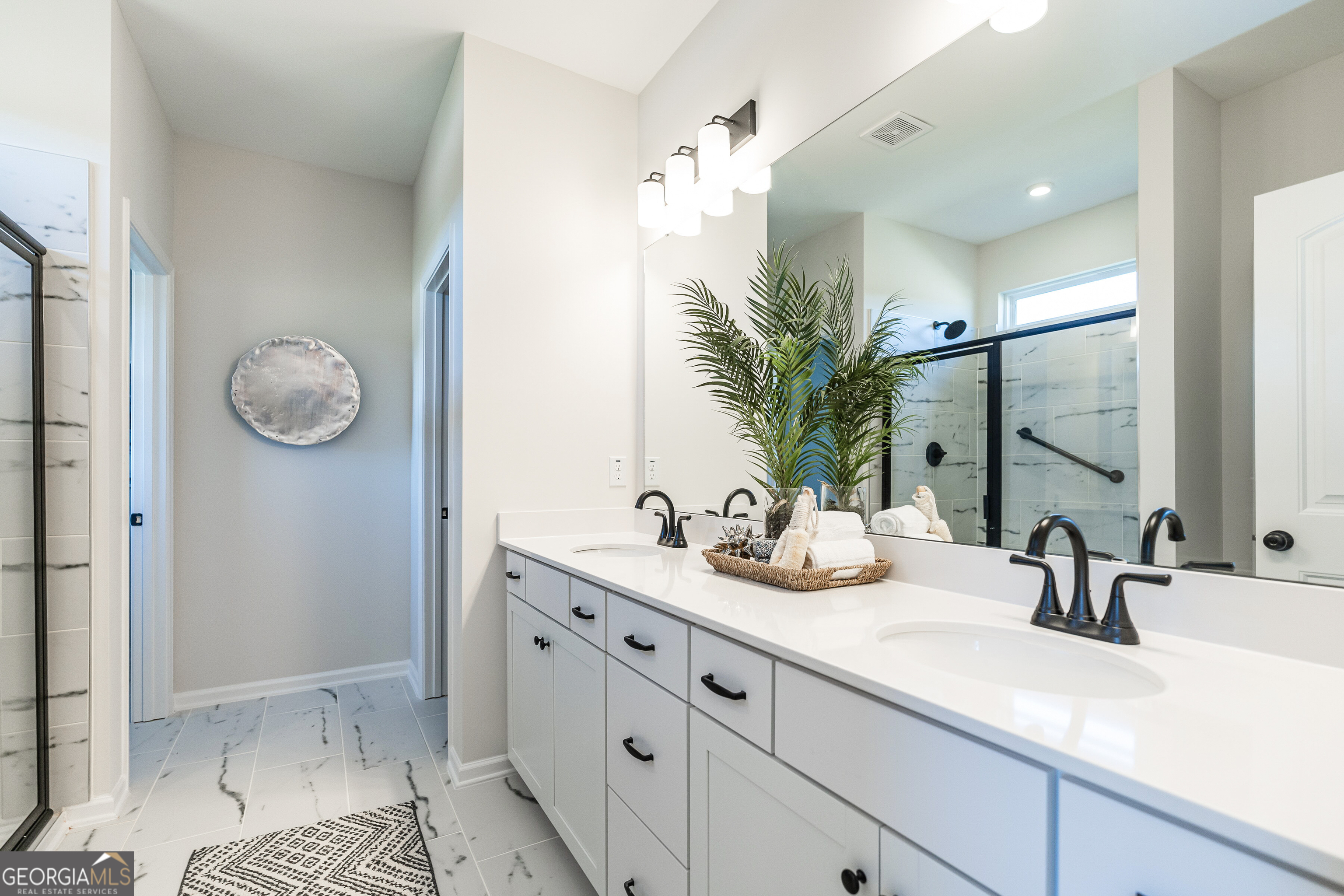 10410 Trellis Lane, Unit (LOT 35) Hampton, GA 30228 - Photo 24 of 28 a bathroom with a double vanity sink mirror and shower