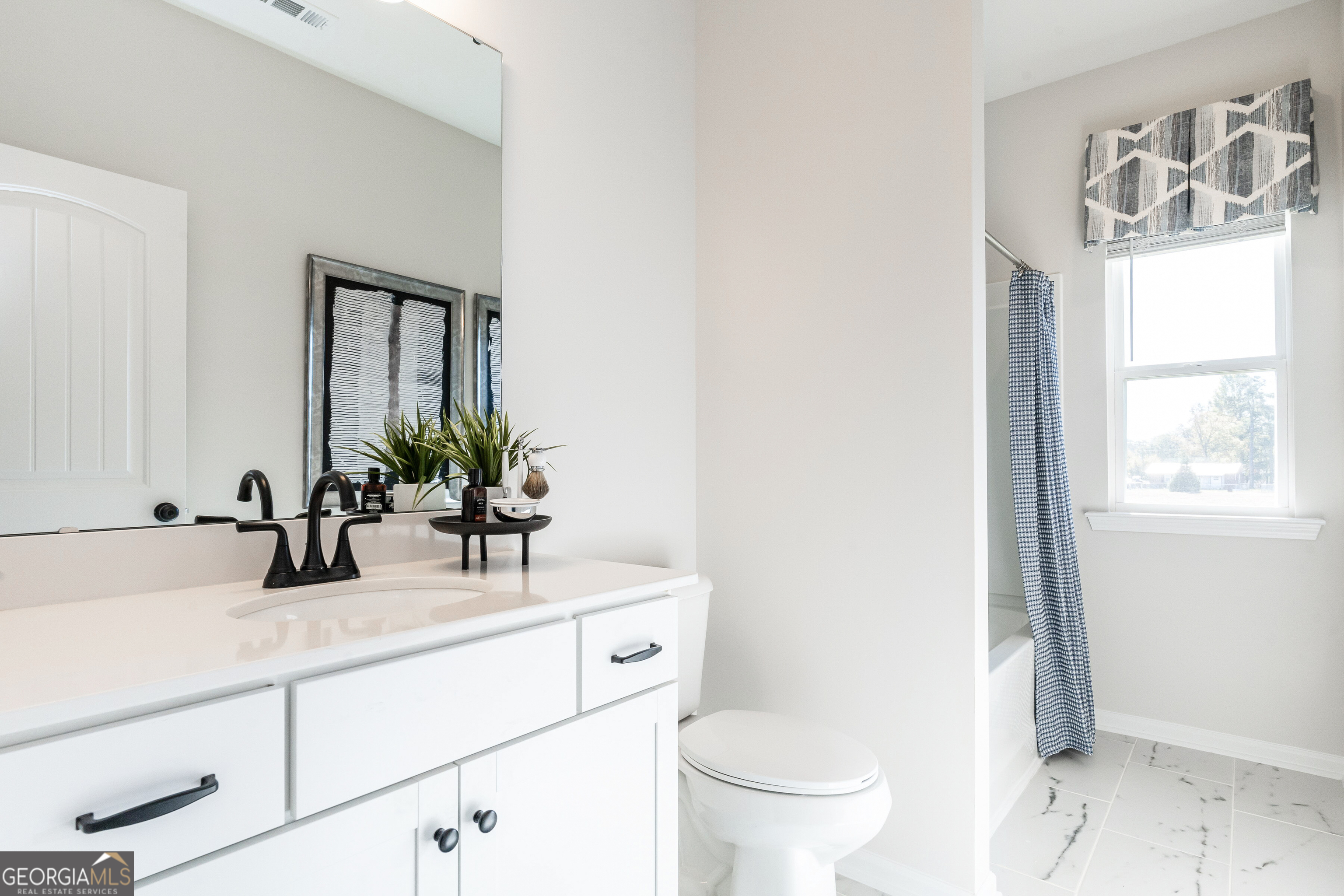 10410 Trellis Lane, Unit (LOT 35) Hampton, GA 30228 - Photo 28 of 28 a bathroom with a sink and a mirror