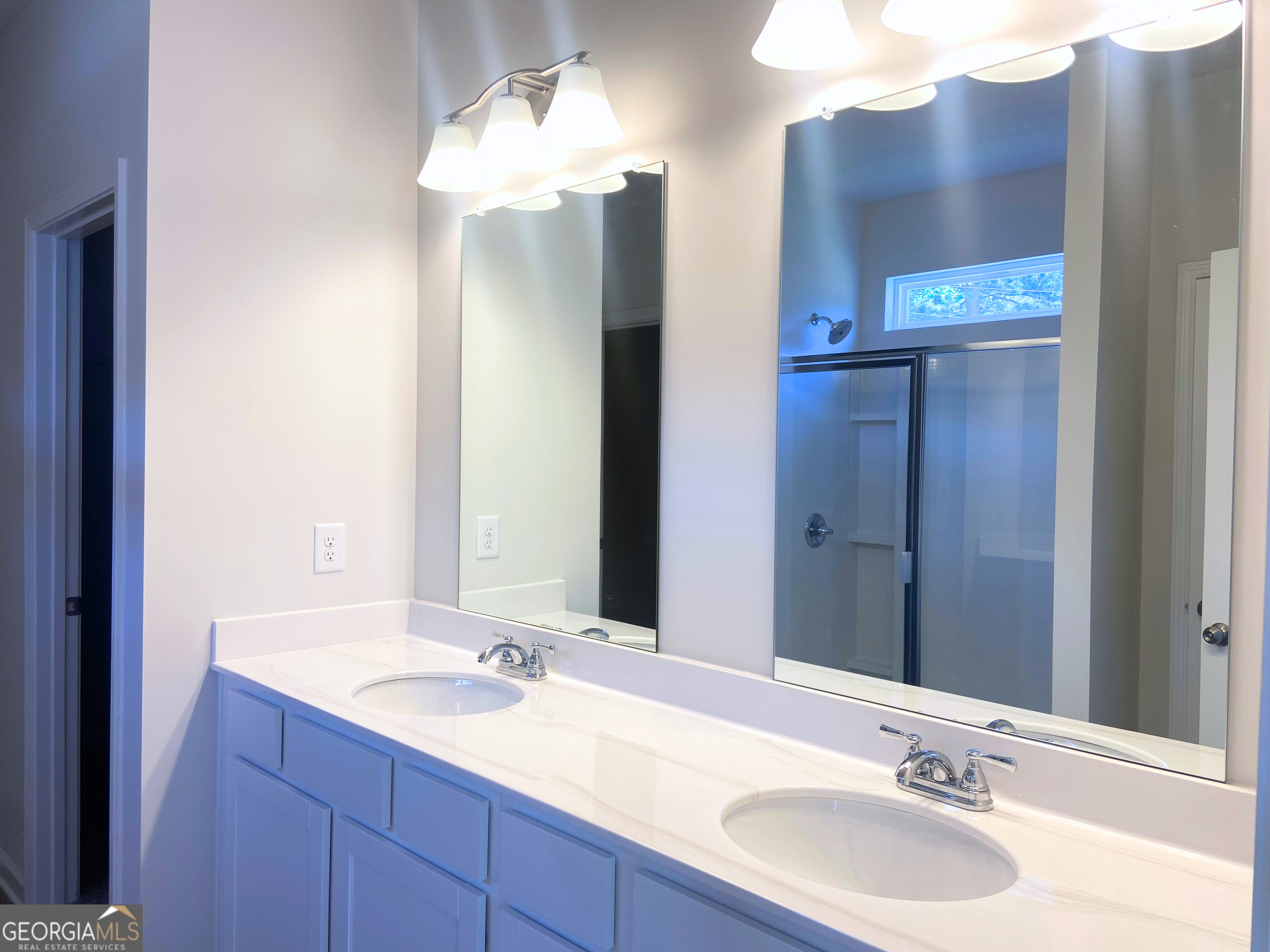 10410 Trellis Lane, Unit (LOT 35) Hampton, GA 30228 - Photo 5 of 28 a bathroom with a double vanity sink and a mirror
