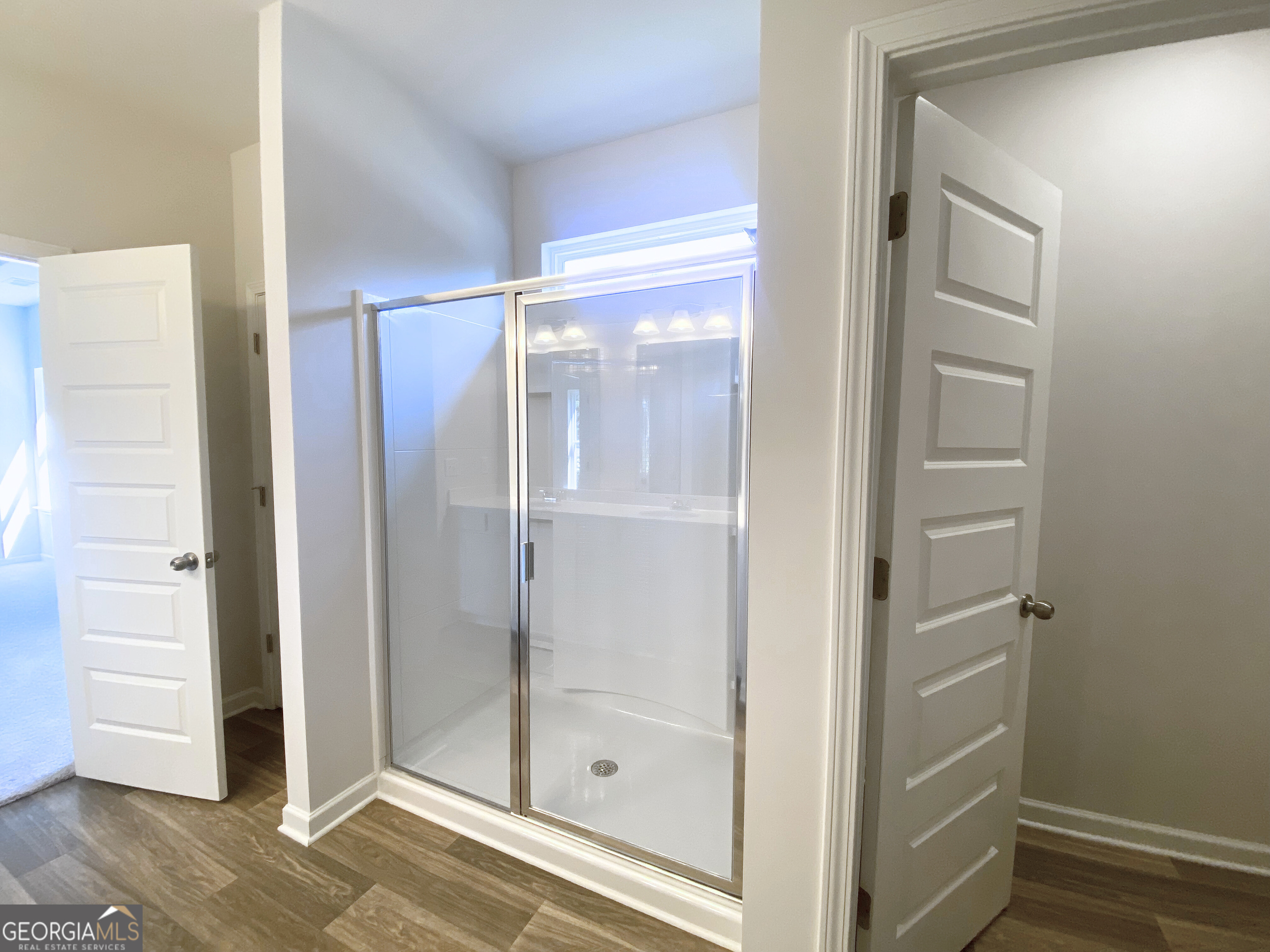 10410 Trellis Lane, Unit (LOT 35) Hampton, GA 30228 - Photo 6 of 28 a bathroom with a glass shower door
