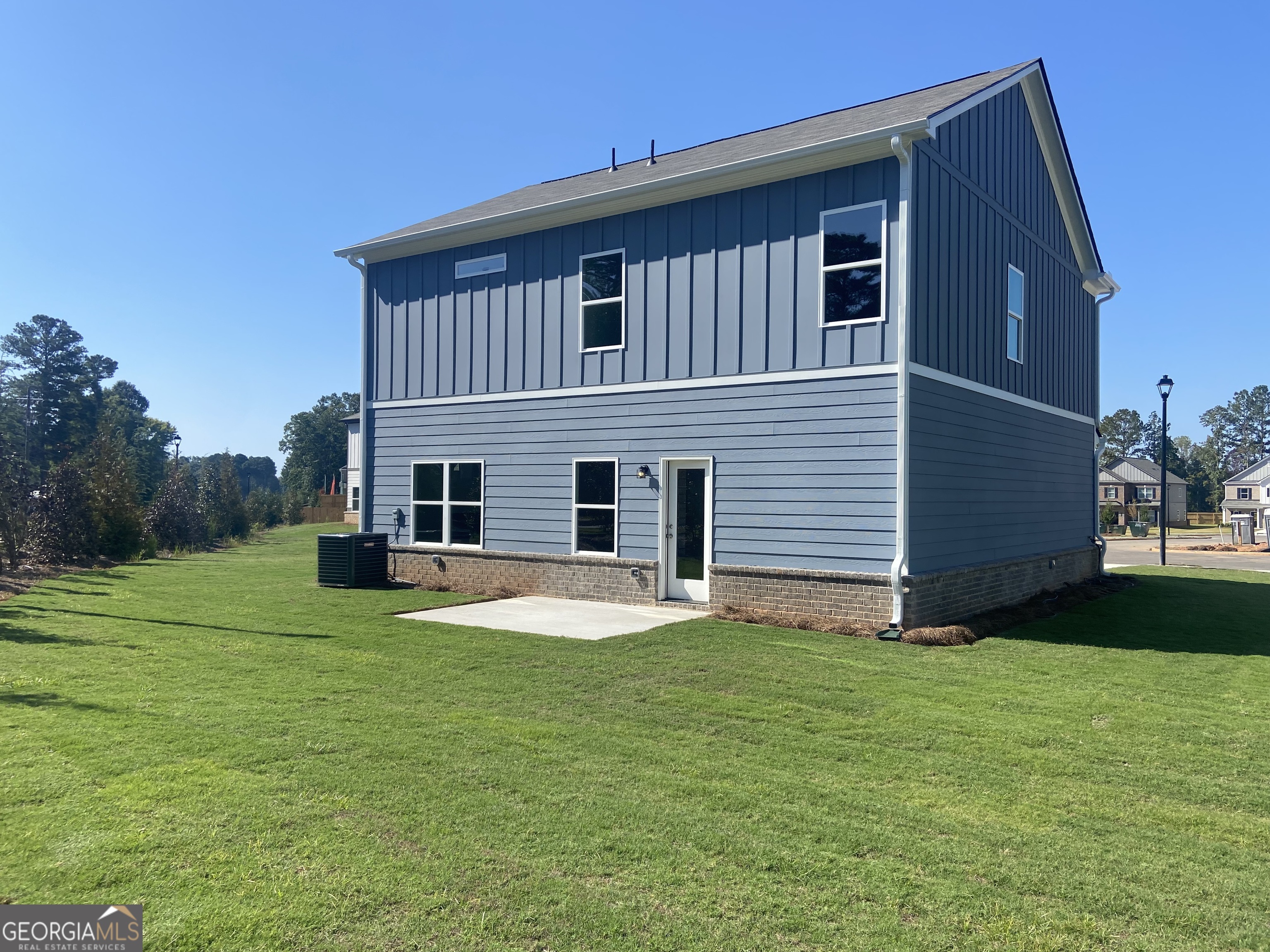 10410 Trellis Lane, Unit (LOT 35) Hampton, GA 30228 - Photo 7 of 28 a front view of a house with garden and trees