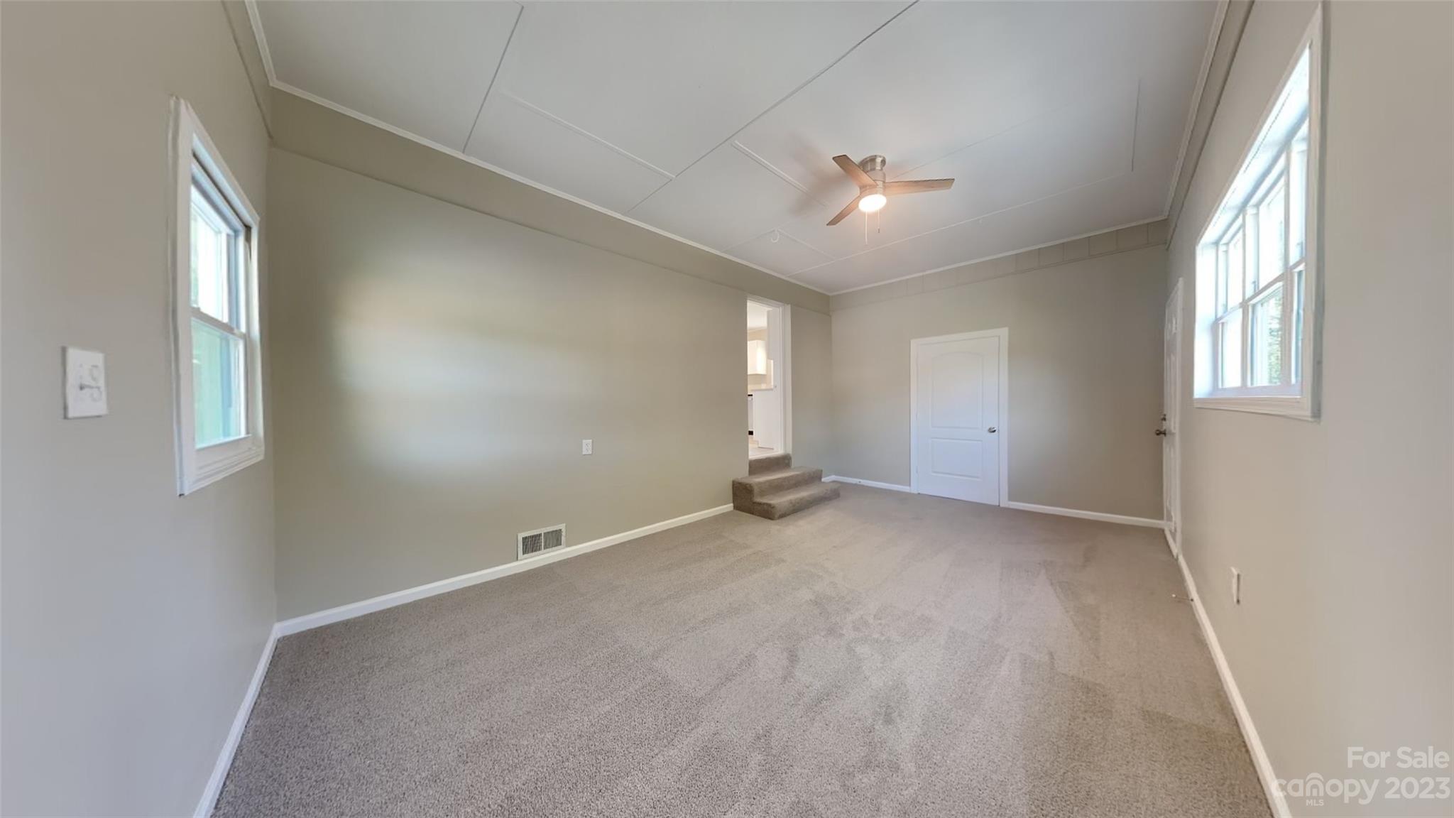 622 Unique Street Chester, SC 29706 - Photo 6 of 12 an empty room with chandelier fan and windows