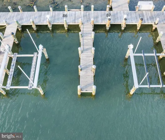 an aerial view of residential houses with outdoor space and parking