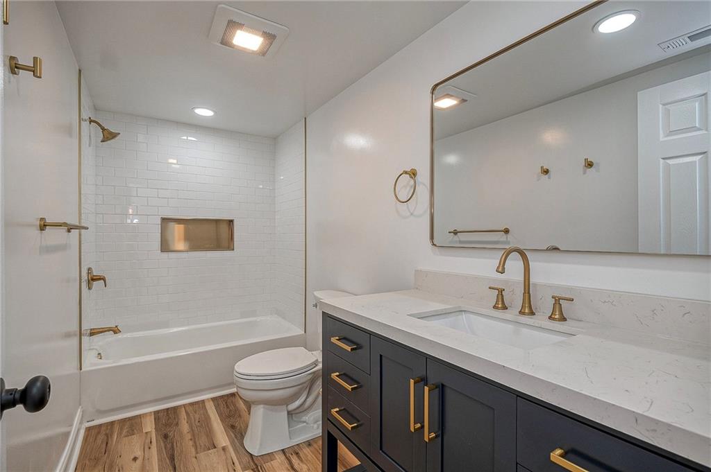242 Dickens Street Latrobe, PA 15650 - Photo 12 of 25 a bathroom with a granite countertop sink toilet a shower and a mirror