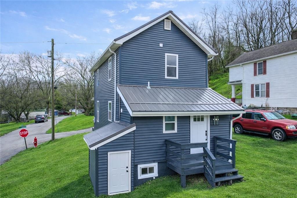 242 Dickens Street Latrobe, PA 15650 - Photo 2 of 25 a front view of a house with a garden