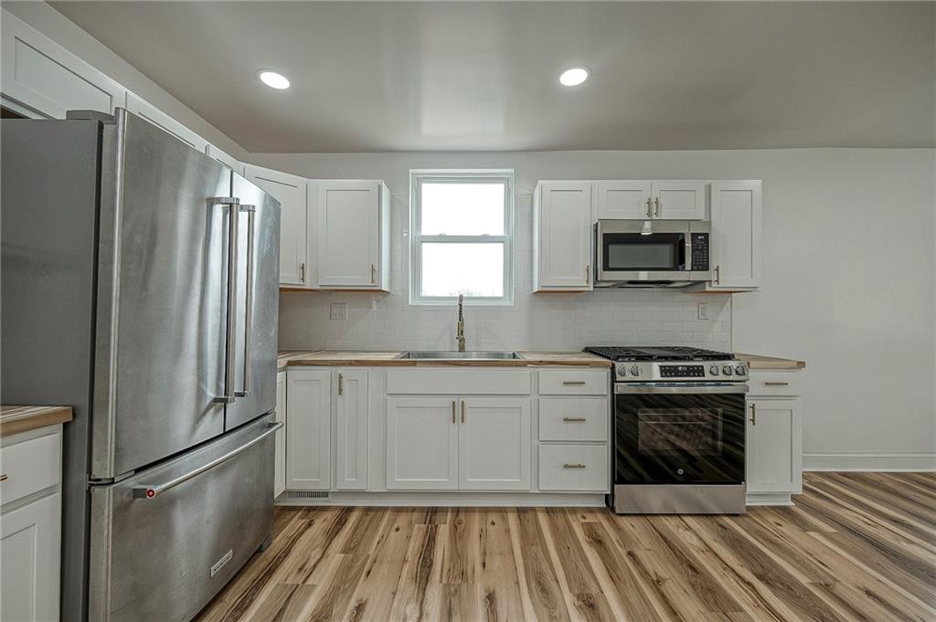 242 Dickens Street Latrobe, PA 15650 - Photo 8 of 25 a kitchen with a sink stove and refrigerator