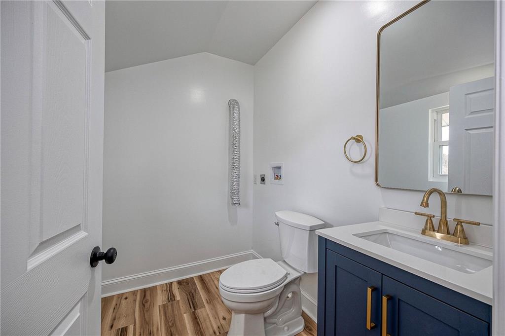 242 Dickens Street Latrobe, PA 15650 - Photo 10 of 25 a bathroom with a granite countertop toilet sink and mirror