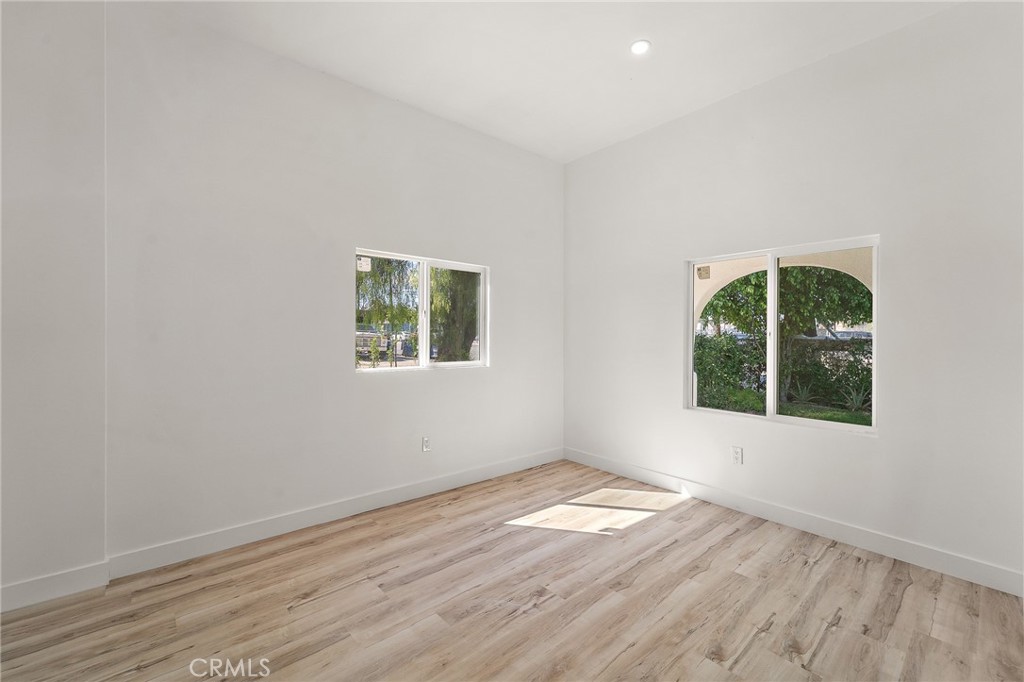 10730 Strathern Street Sun Valley, CA 91352 - Photo 11 of 57 an empty room with wooden floor and windows