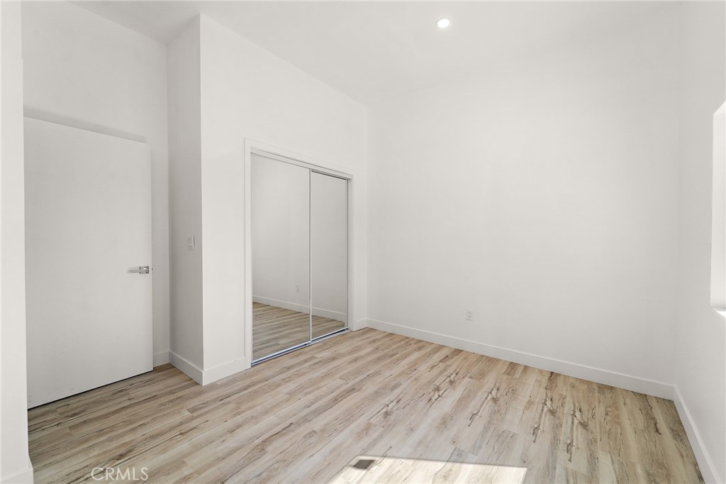 10730 Strathern Street Sun Valley, CA 91352 - Photo 17 of 57 a view of an empty room with wooden floor
