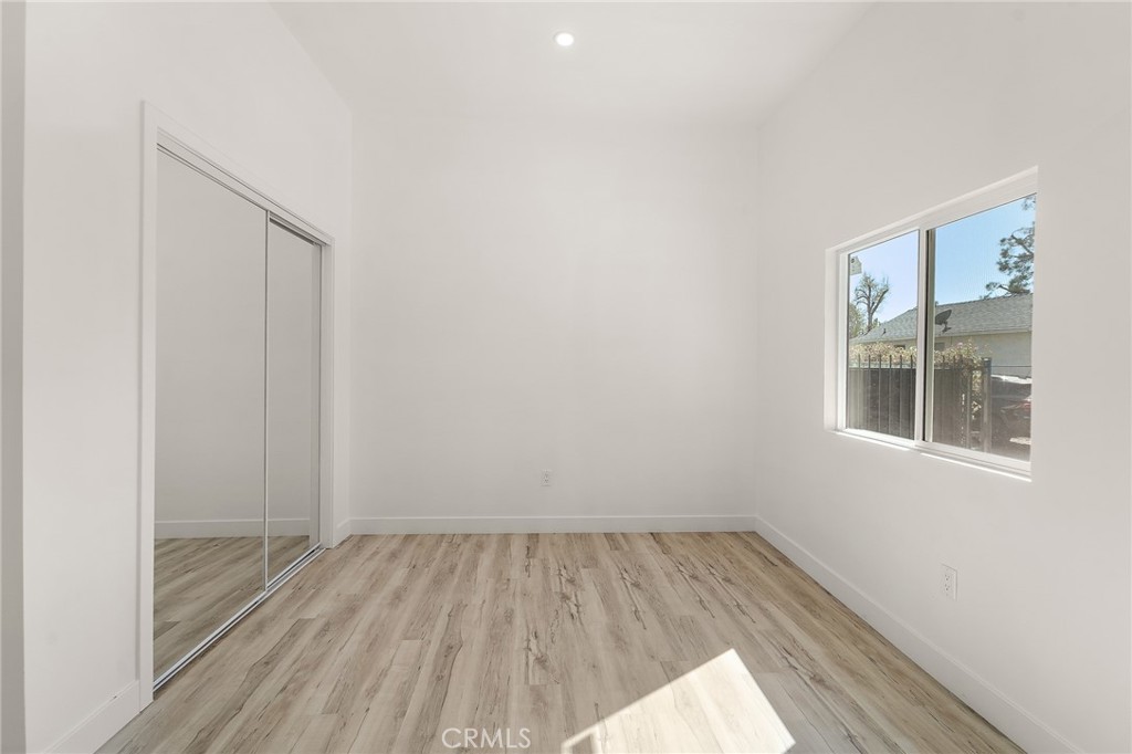 10730 Strathern Street Sun Valley, CA 91352 - Photo 18 of 57 an empty room with wooden floor and windows