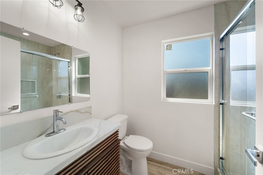 10730 Strathern Street Sun Valley, CA 91352 - Photo 19 of 57 a bathroom with a sink toilet and a mirror