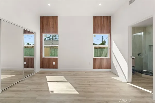 an empty room with wooden floor and a window