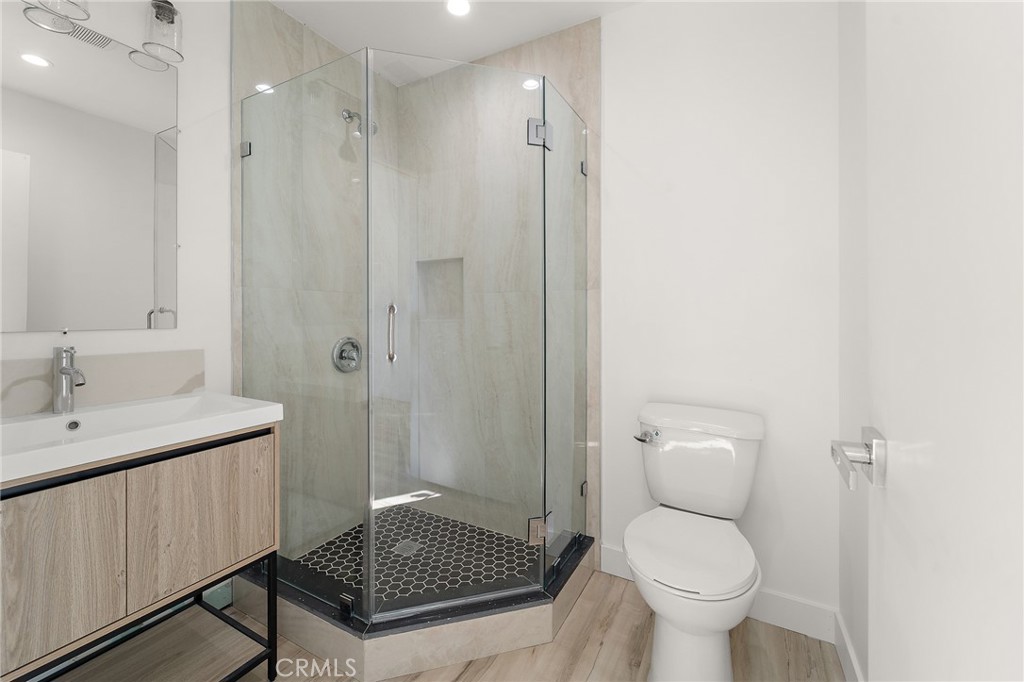 10730 Strathern Street Sun Valley, CA 91352 - Photo 24 of 57 a bathroom with a sink toilet a mirror and shower