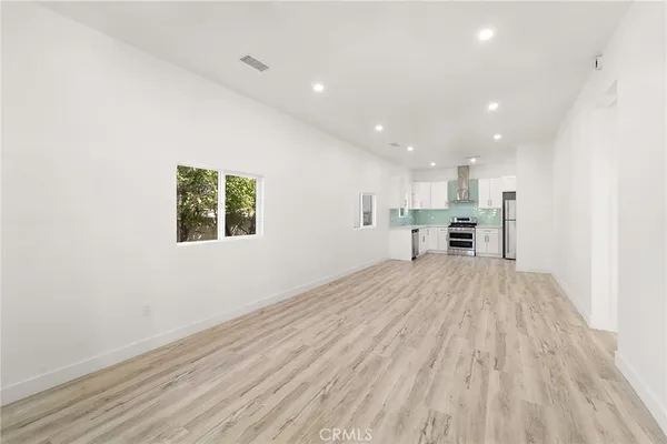 a view of kitchen with stainless steel appliances a refrigerator and a microwave